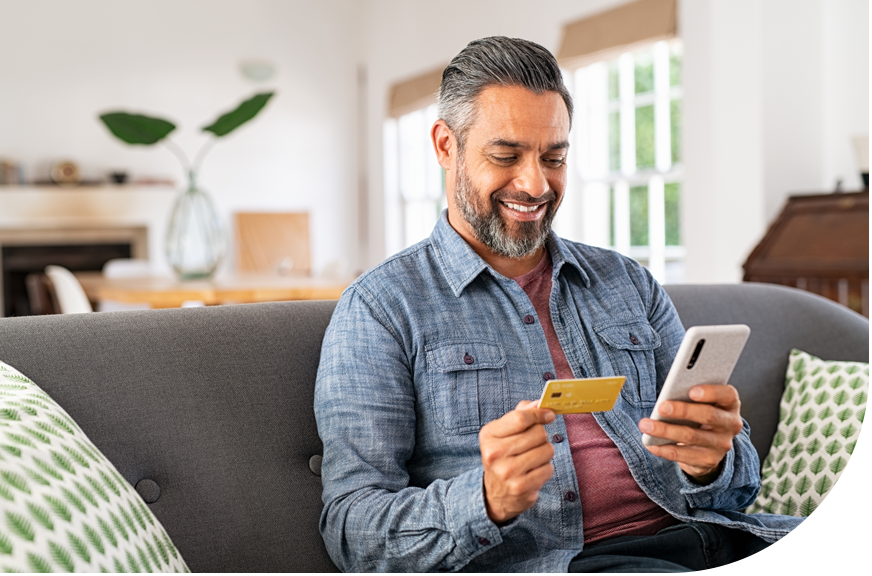 gift card program_man holding gift card using mobile device