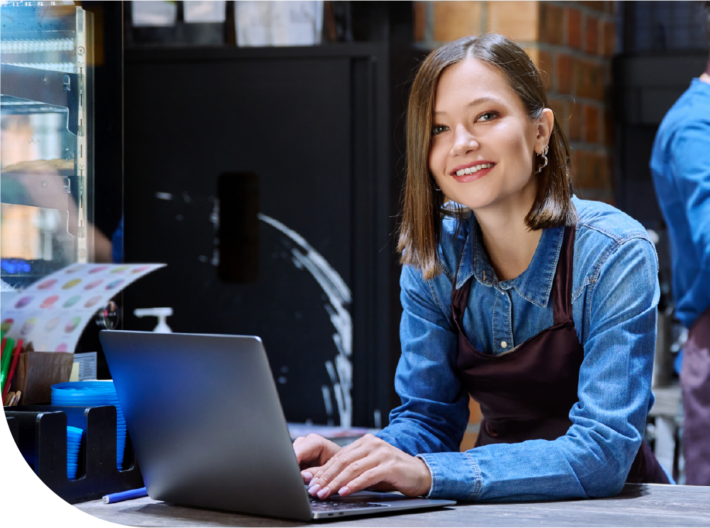 Business owner making data-driven decisions on a laptop with Lighthouse Business Manager | Shift4