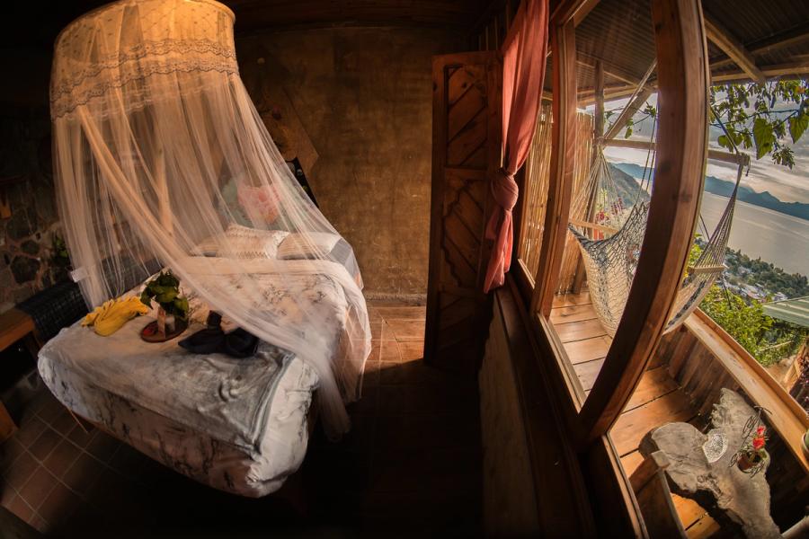 The Elephant room at Eagle's Nest: a bed under a white mosquito net and a hammock on the balcony overlooking Lake Atitlan