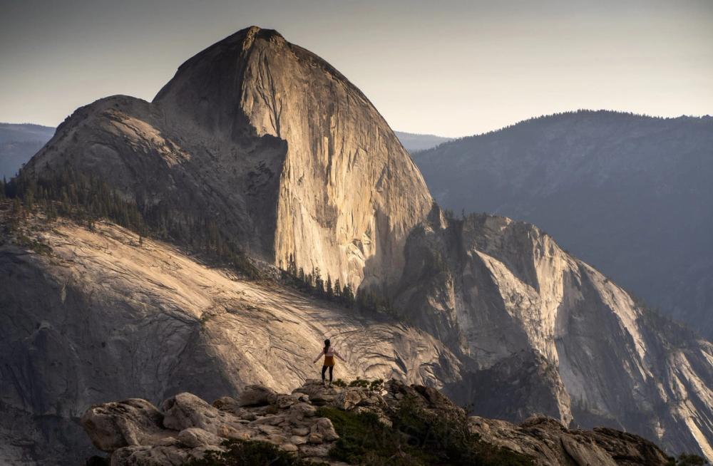 Hiker below Half Dome at sunset
