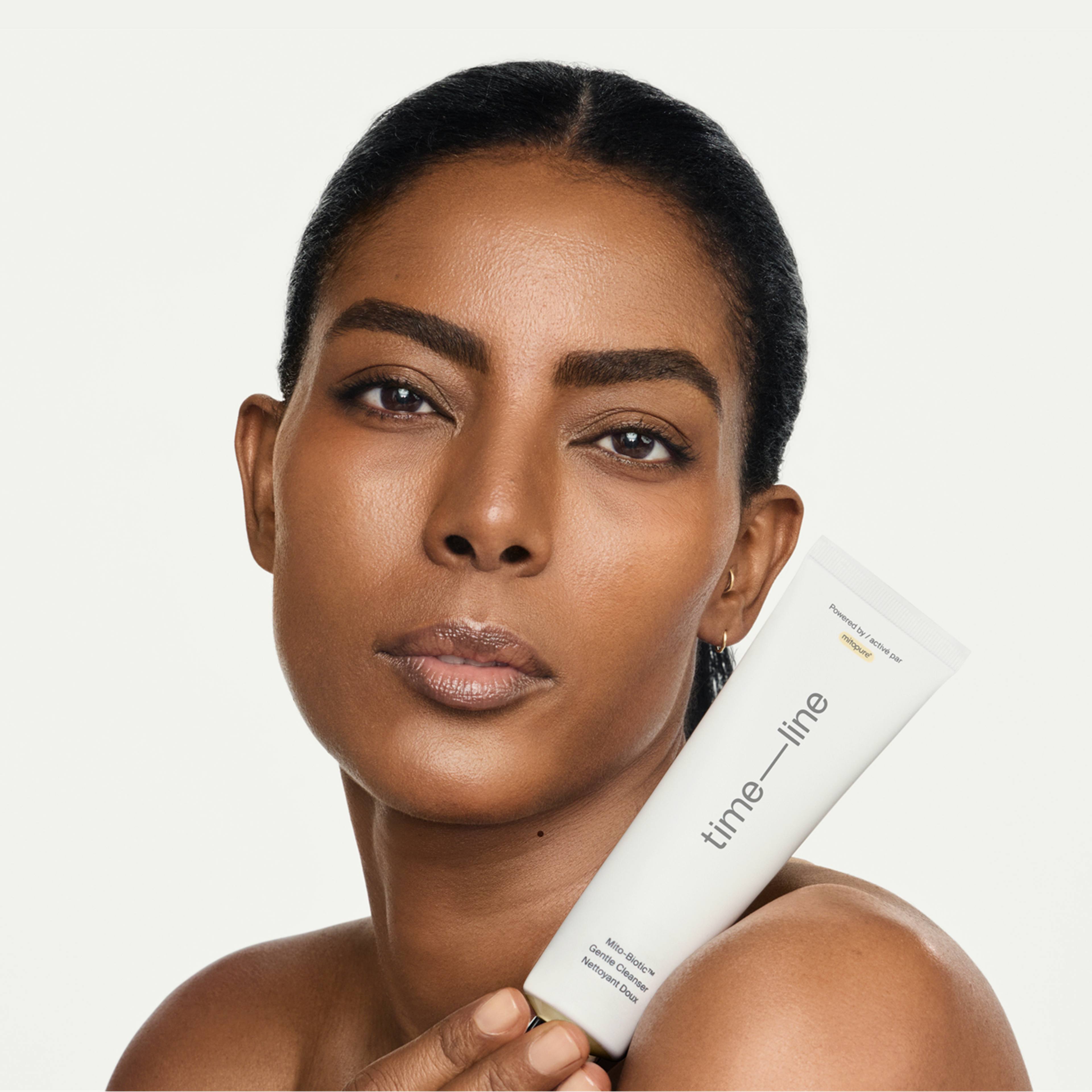 Woman holding Mitopure Gentle Cleanser