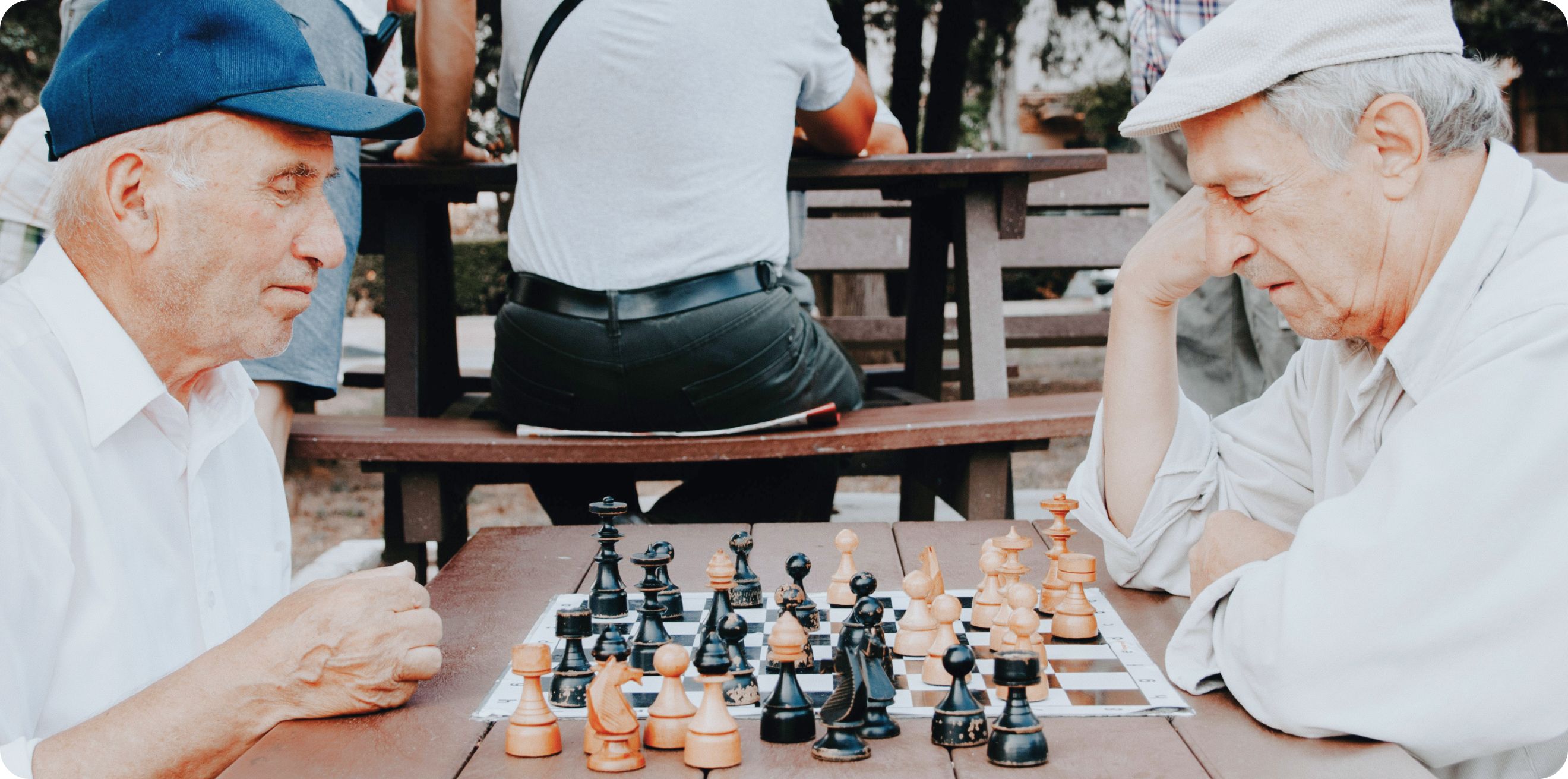Two older men playing chess
