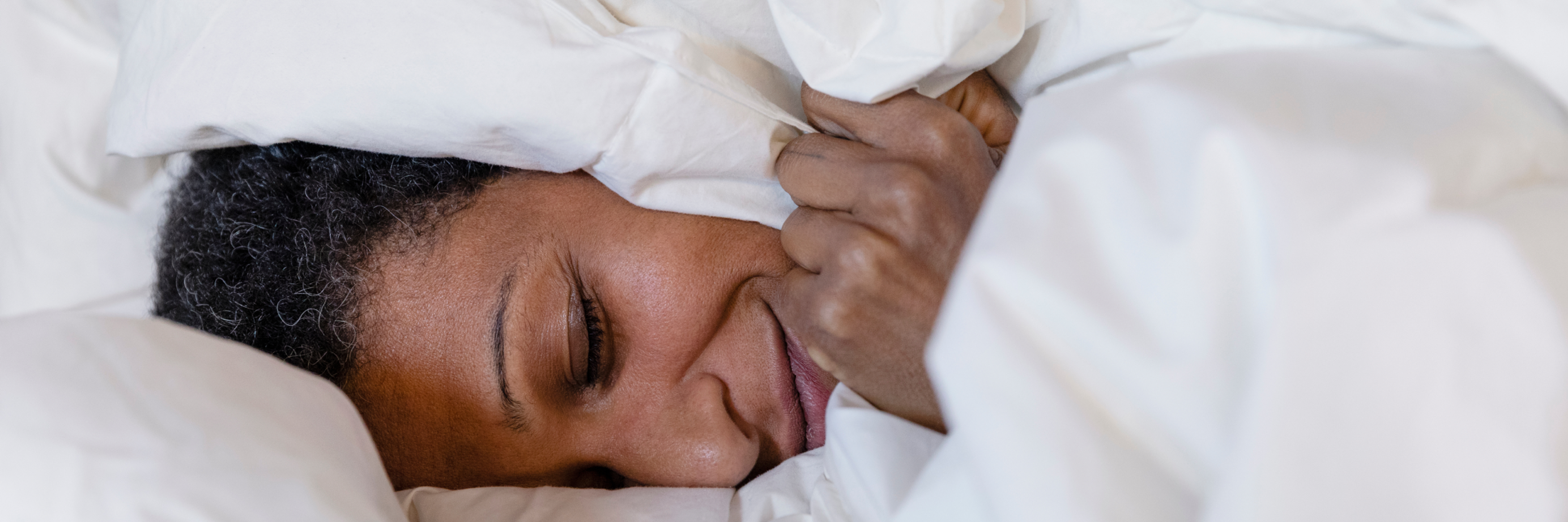 Person smiling in bed