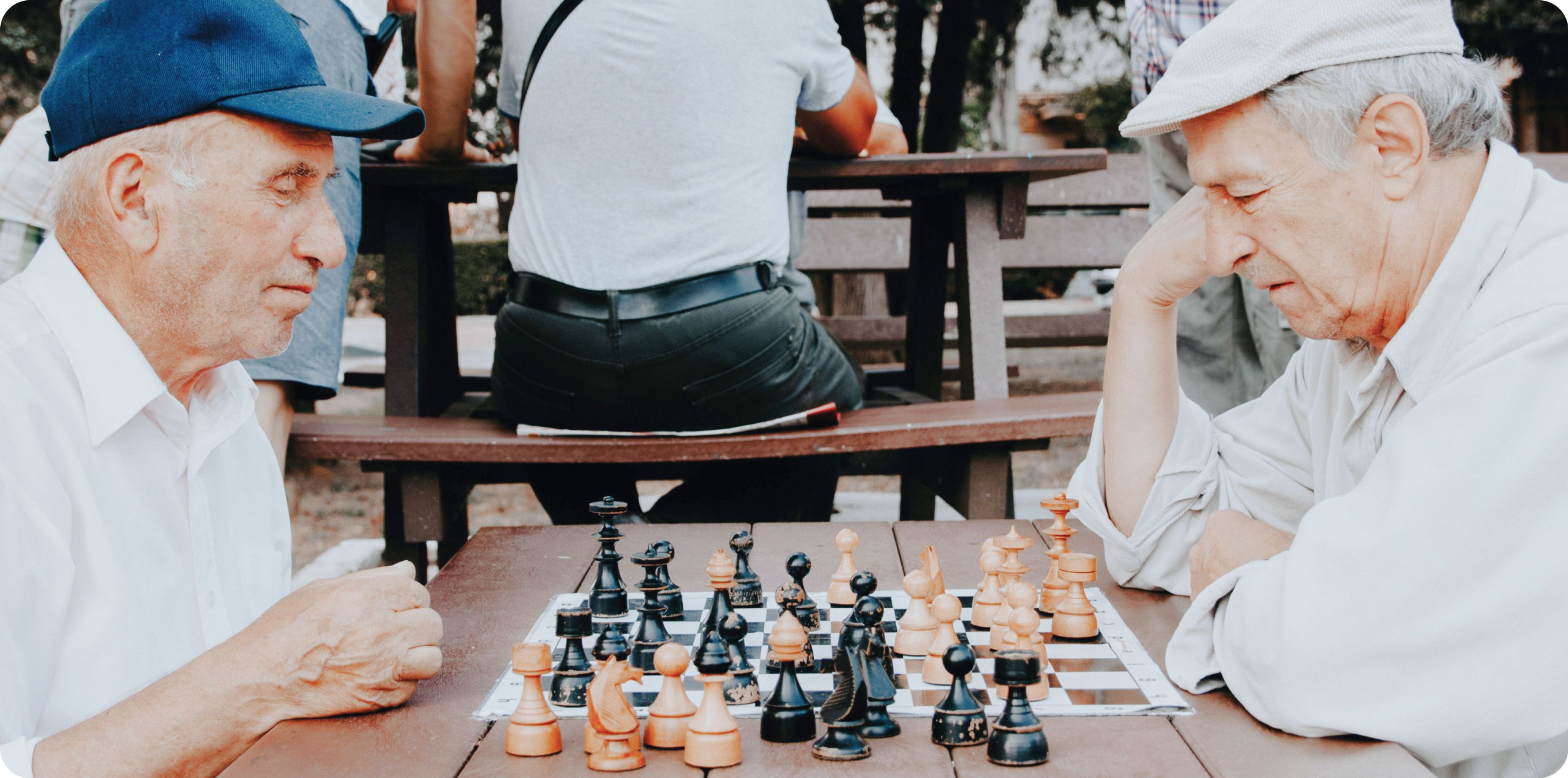 Two older men playing chess