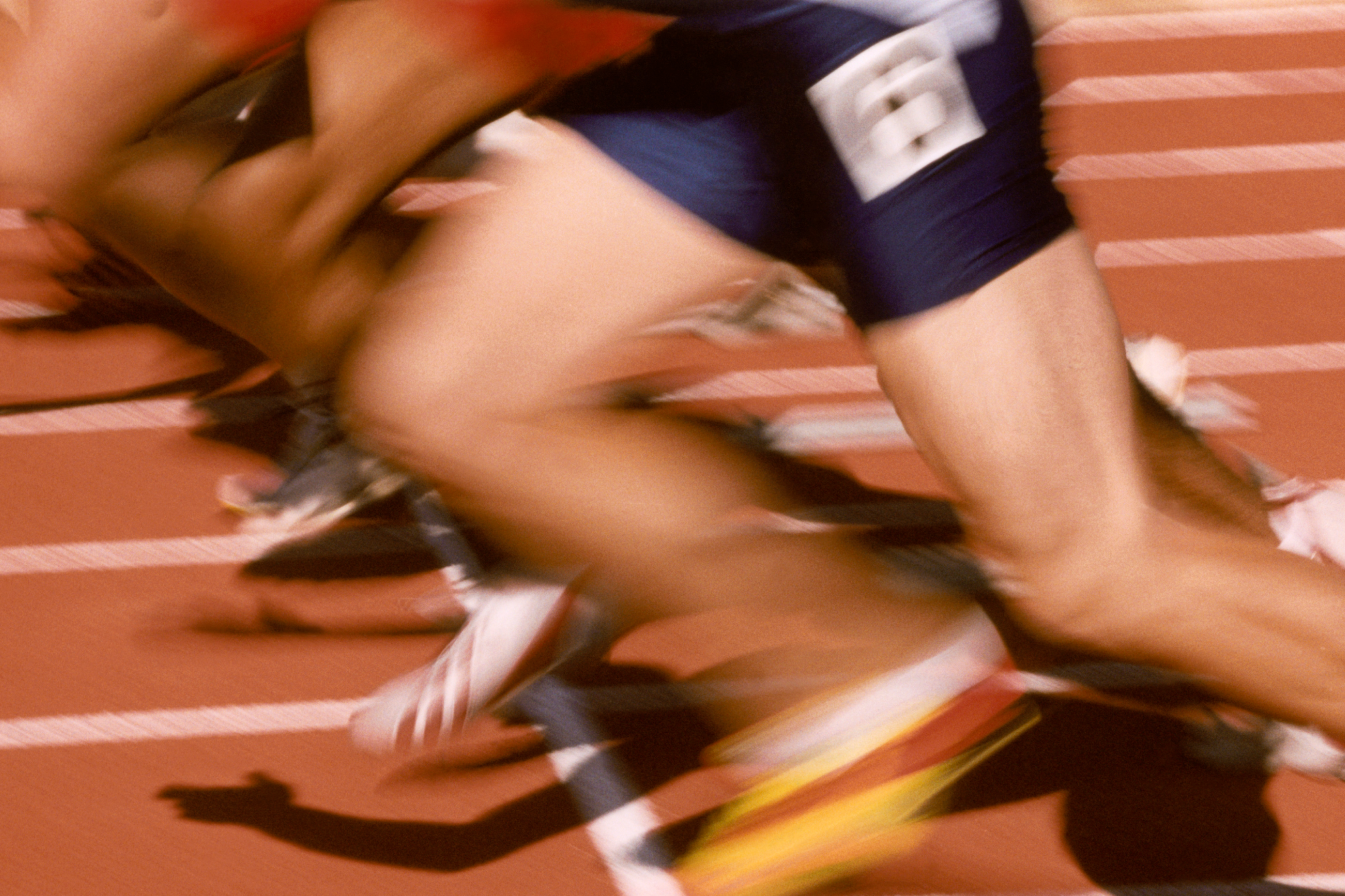 Athletes running on a running track