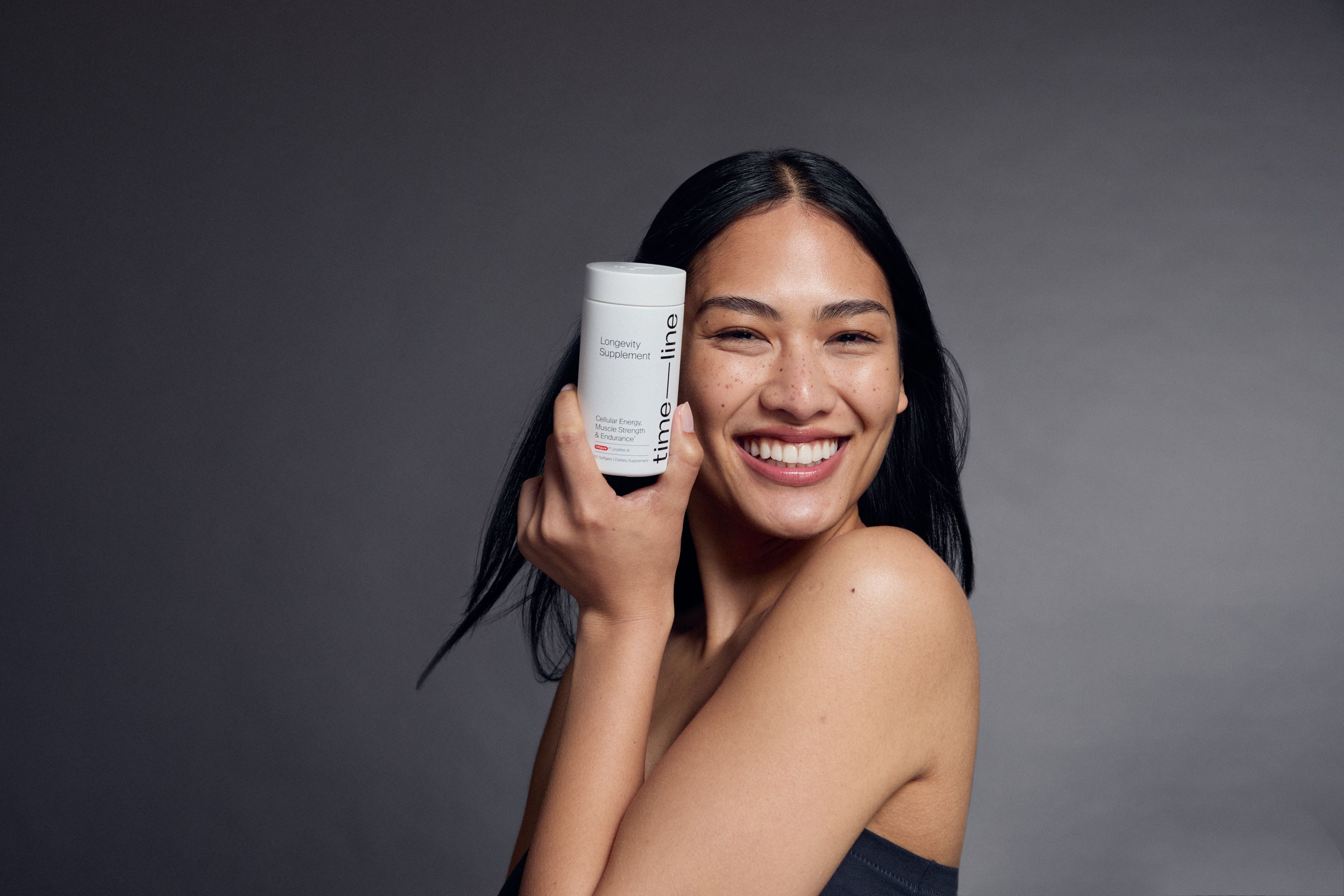 woman holding Urolithin A Softgels