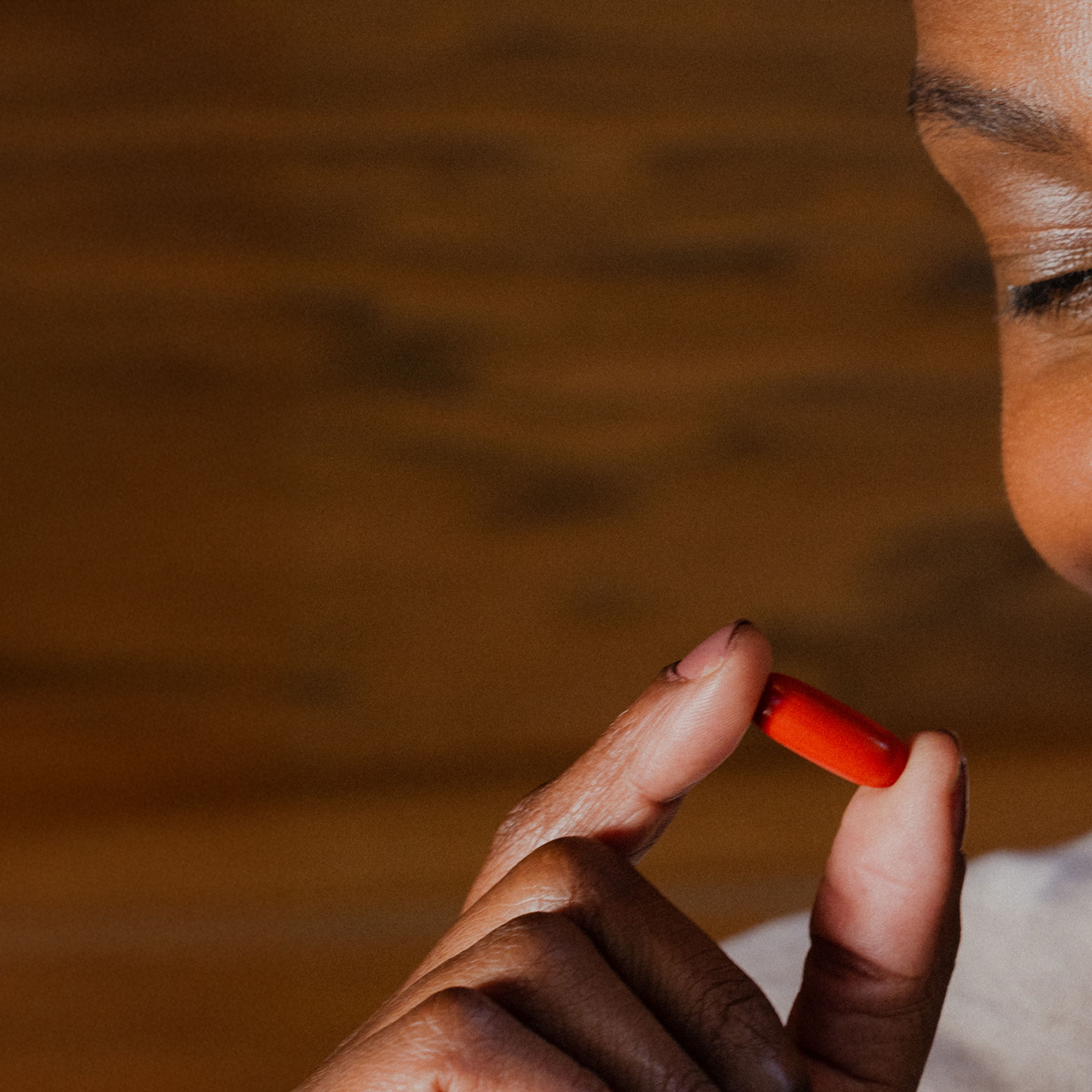 Smiling women holding softgel