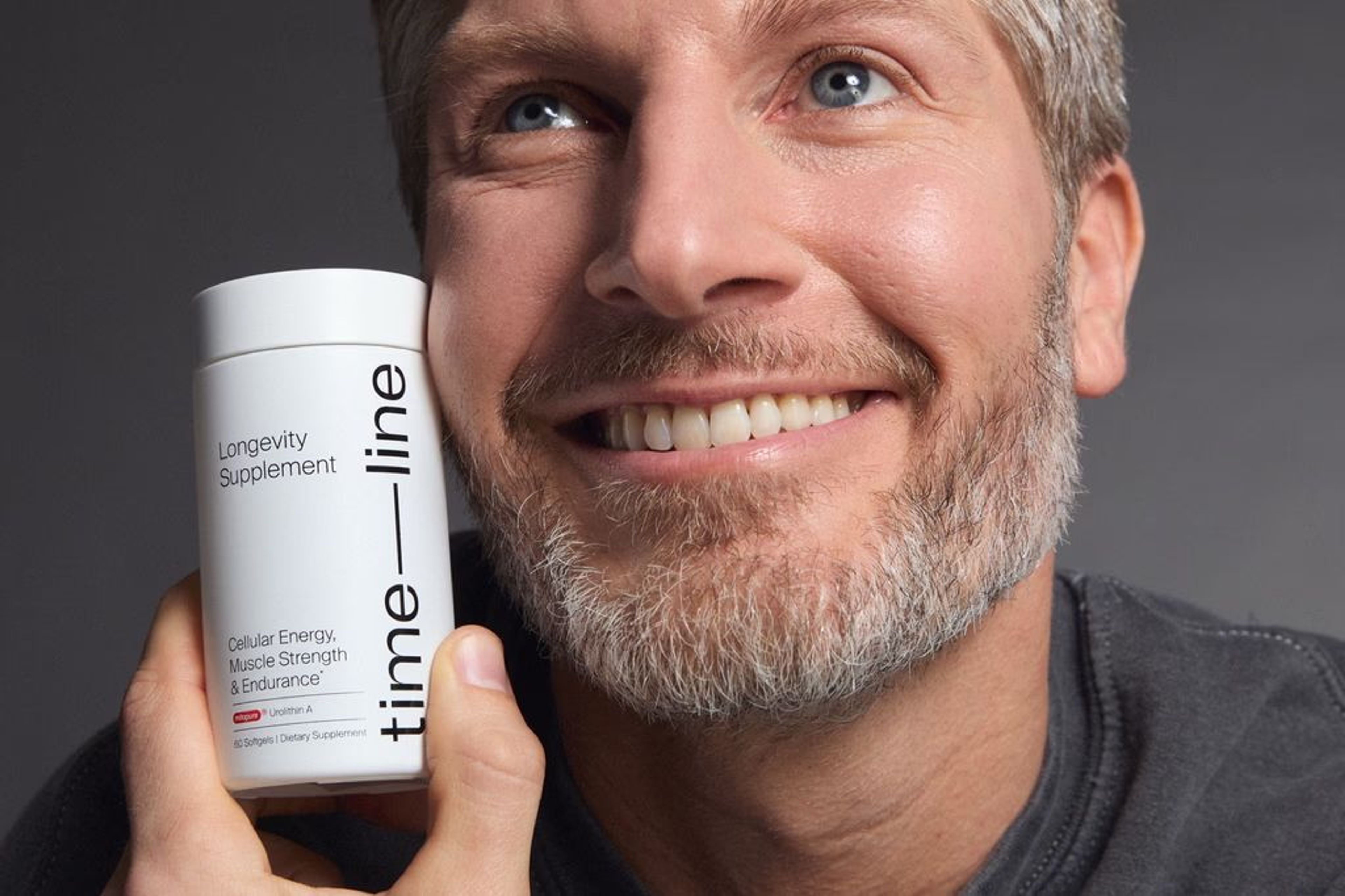 Smiling man with Mitopure Softgels