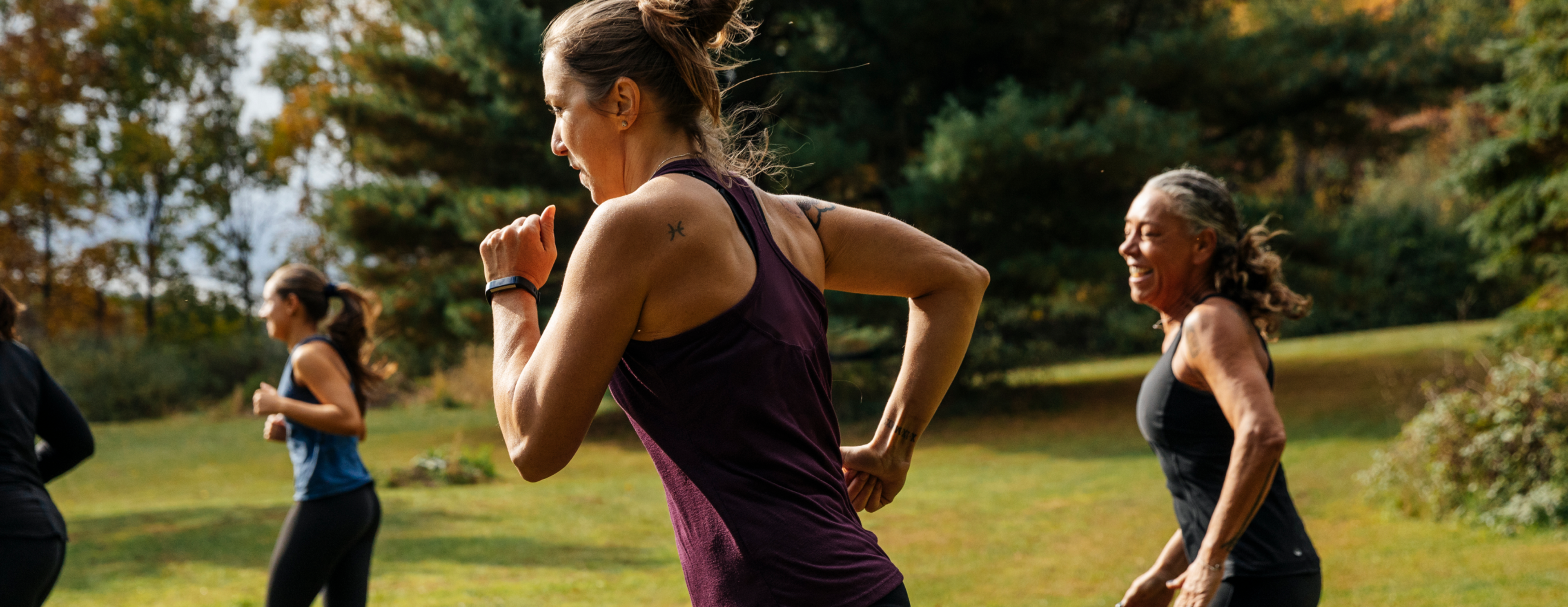 A group of people running in a park