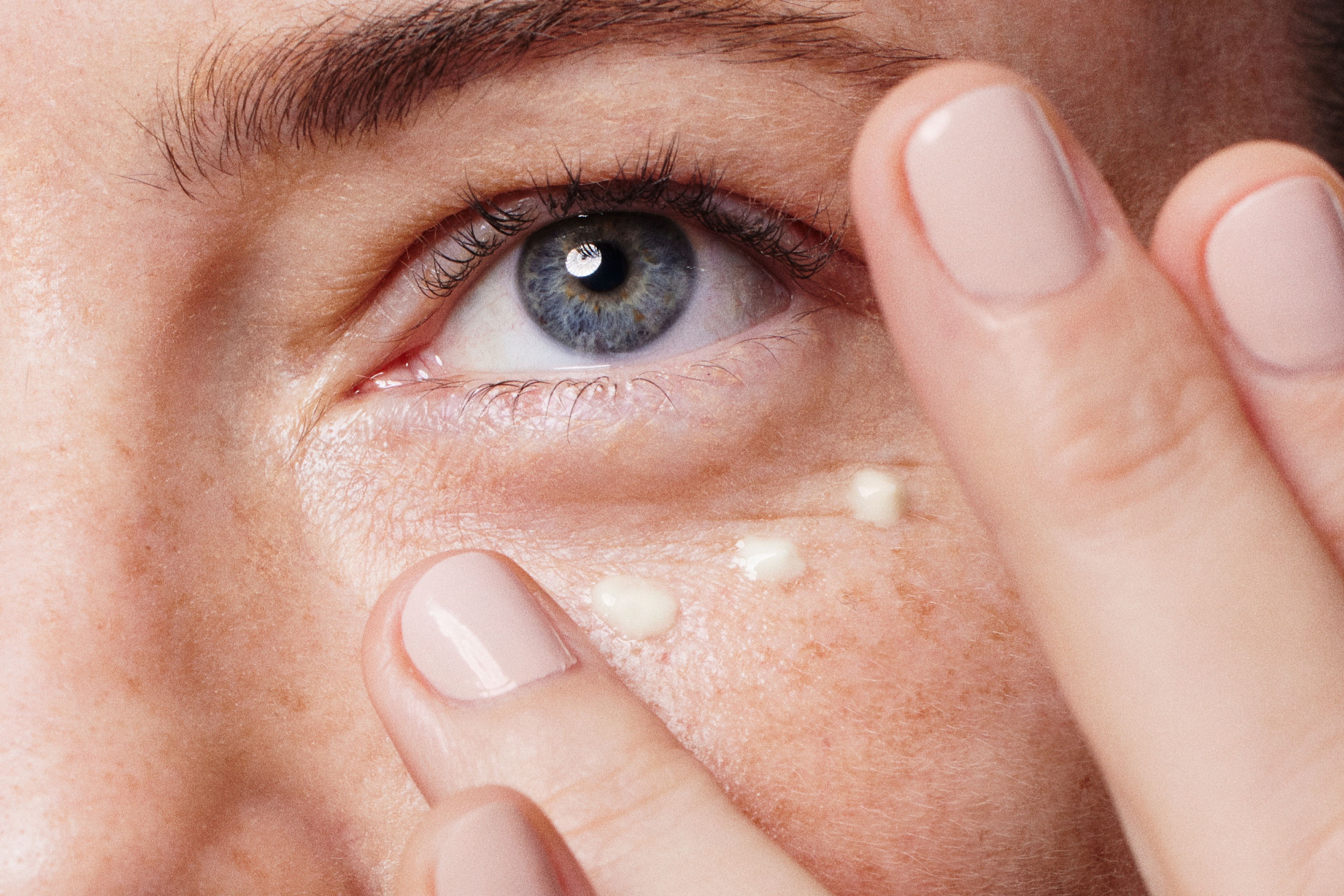 Massaging and applying cream on the eye area