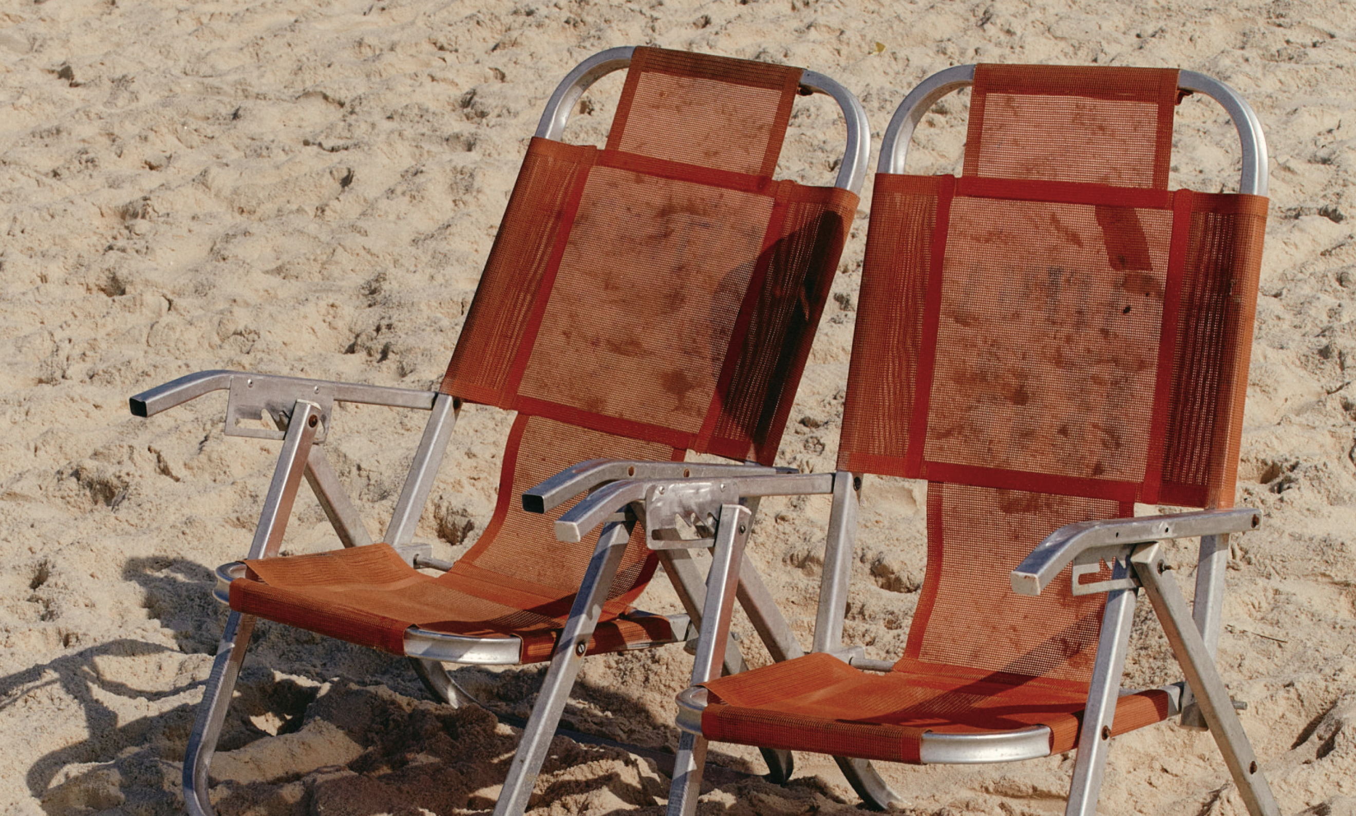 2 empty chairs at the beach