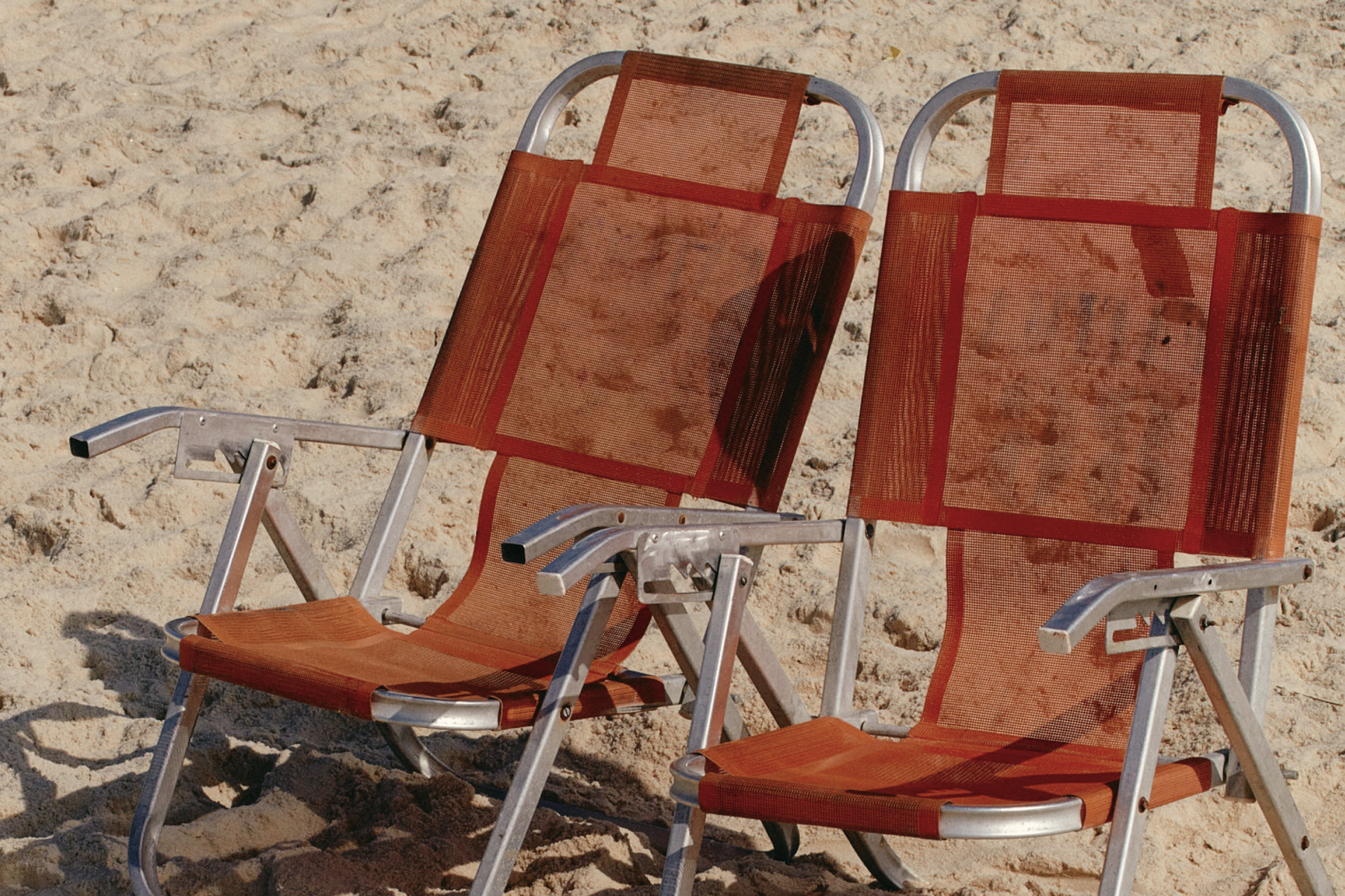 2 empty chairs at the beach