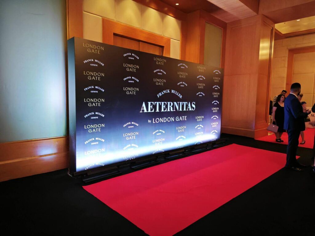 Red carpet and branded backdrop for a luxury brand launch