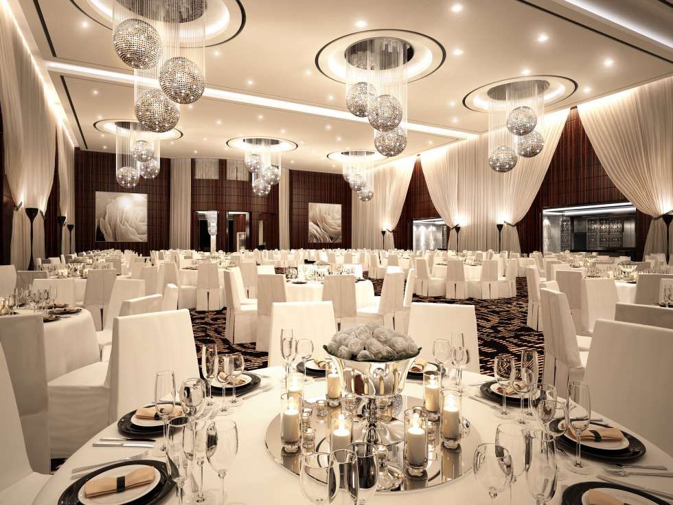 Luxurious white banquet setup with chandeliers in a hotel ballroom
