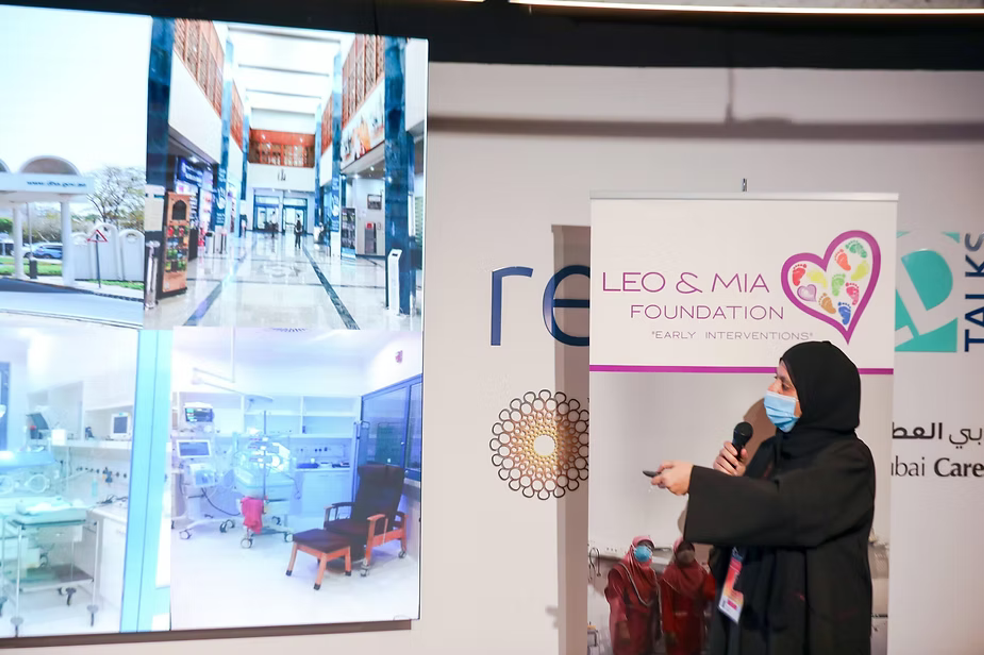 Presenter speaking at a healthcare foundation exhibition stand