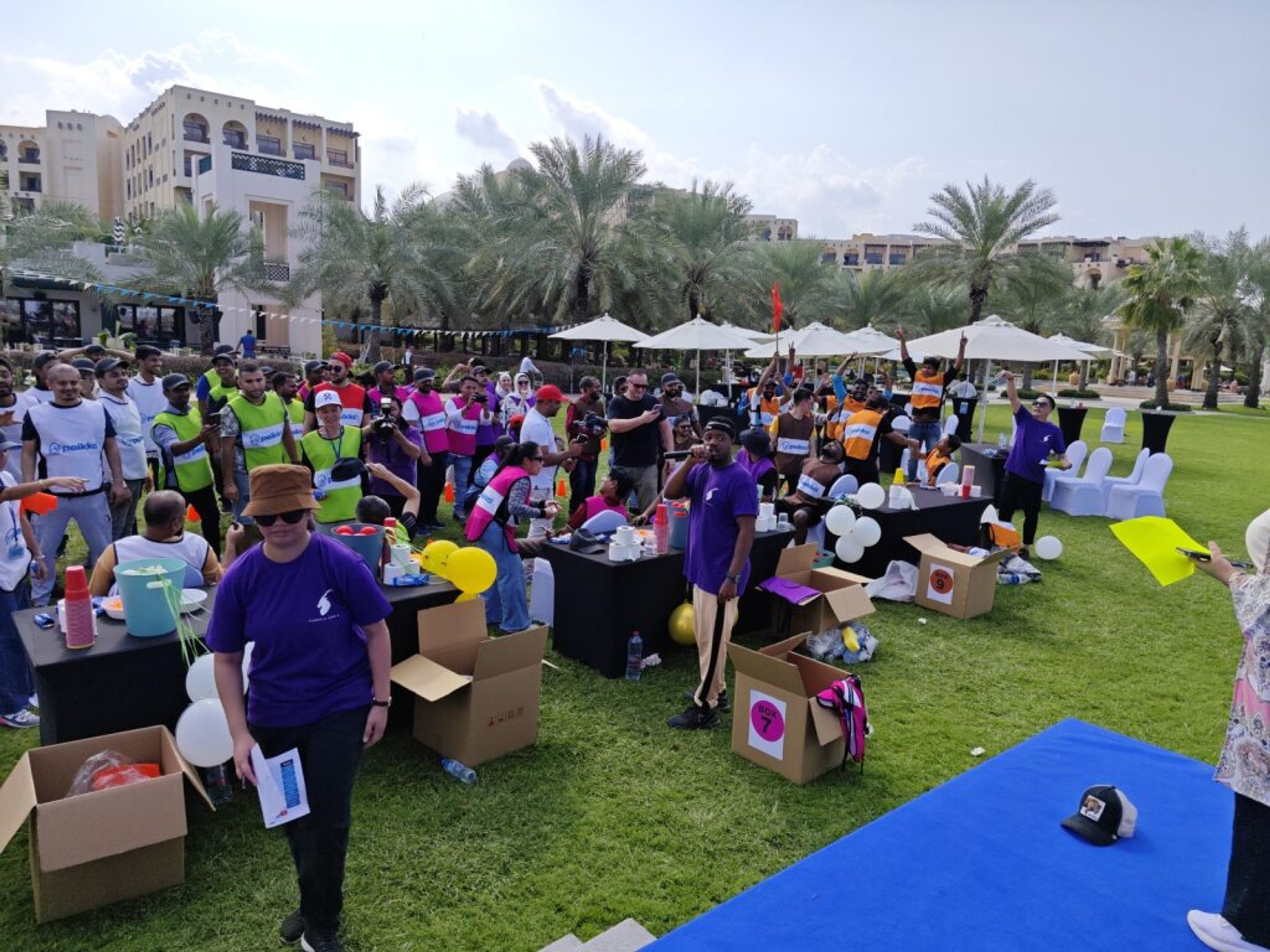 Employees gathered on a lawn for an outdoor family day