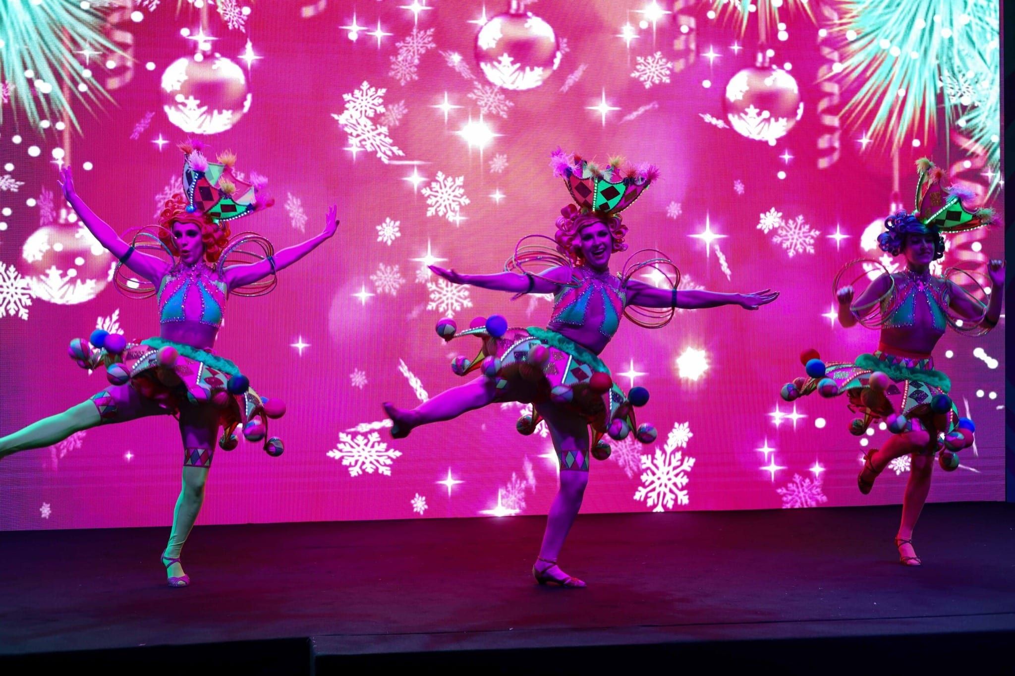 Christmas-themed dancers performing in front of the LED screen at the CANPACK family day