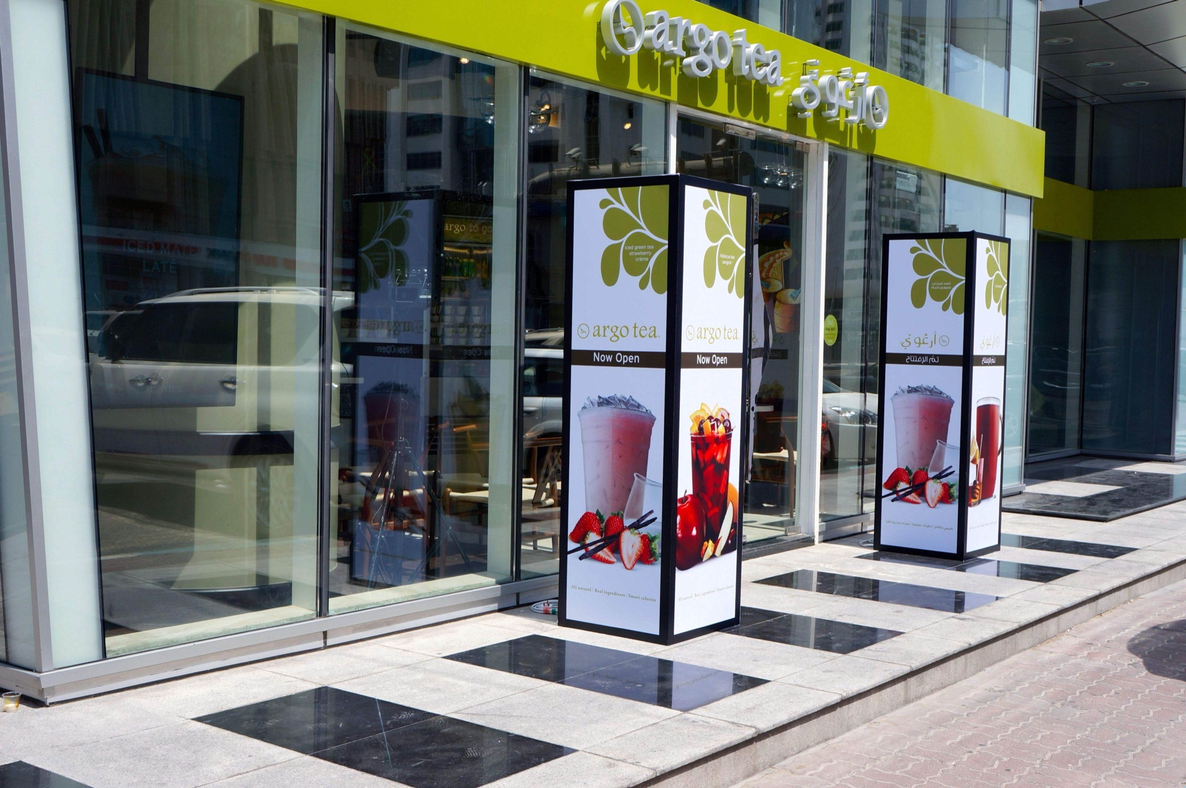 Branded Now Open display pillars at a new store entrance in Dubai