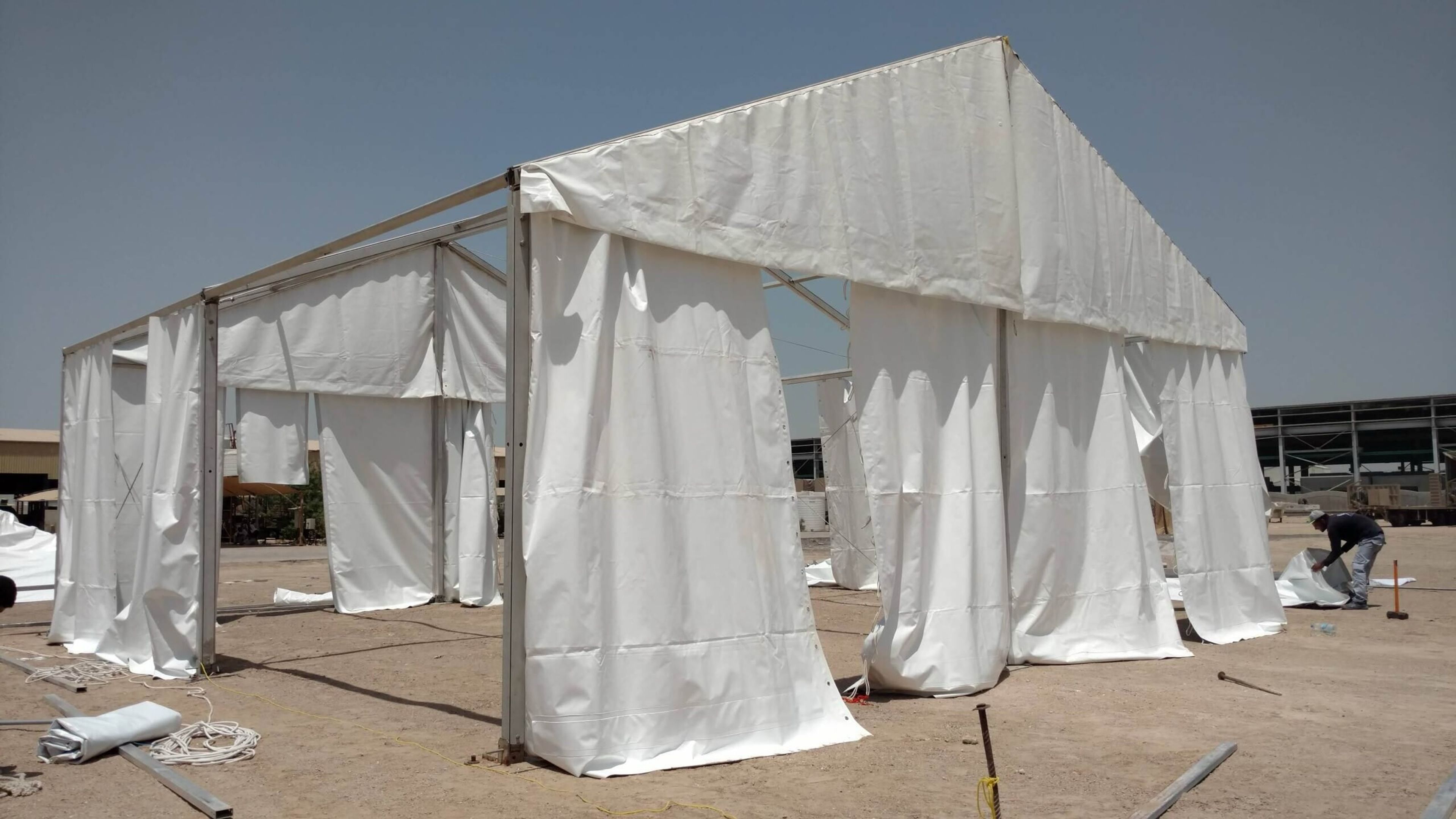 White marquee tents set up for an outdoor event in Dubai