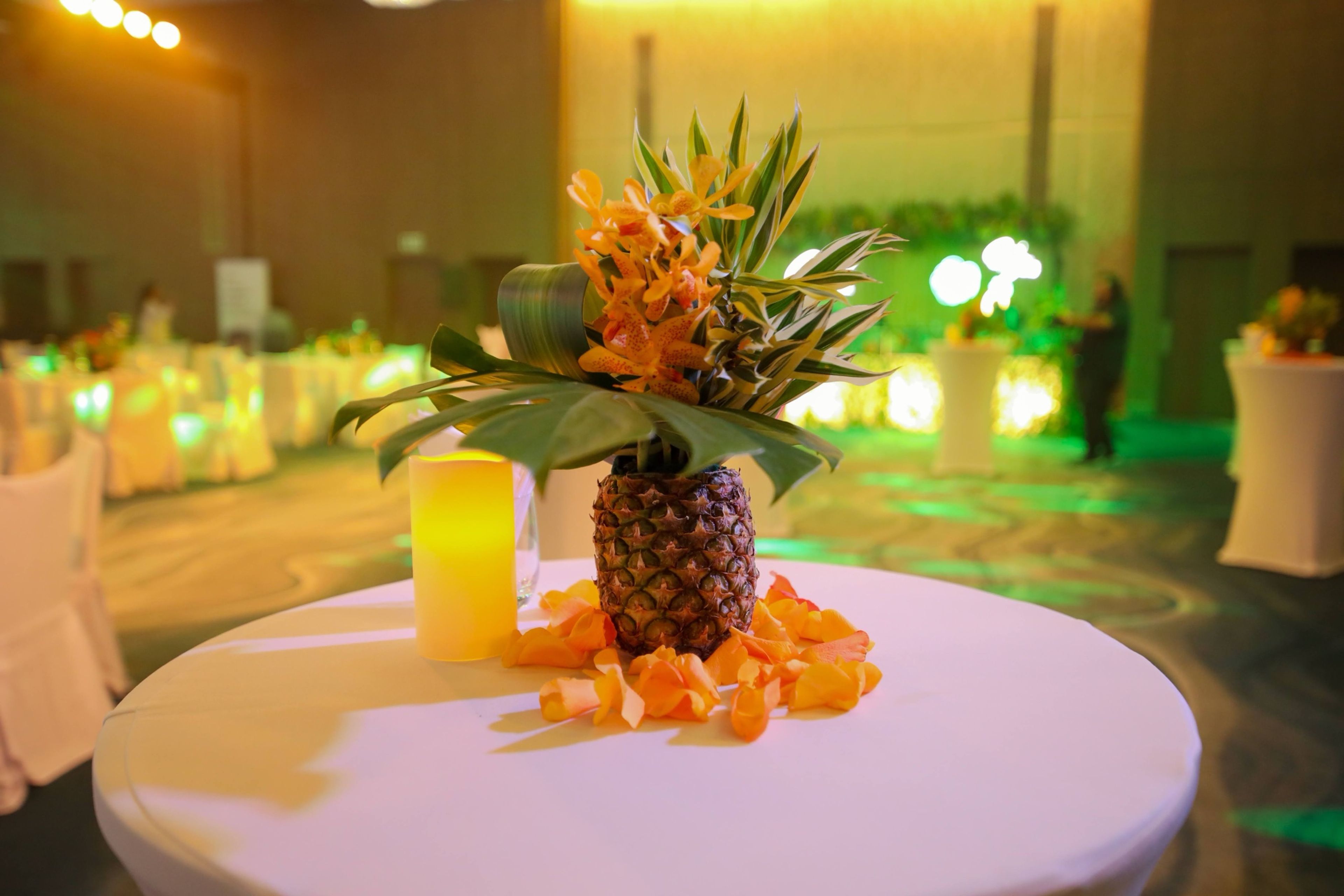 Tropical table centrepiece with a pineapple and flowers