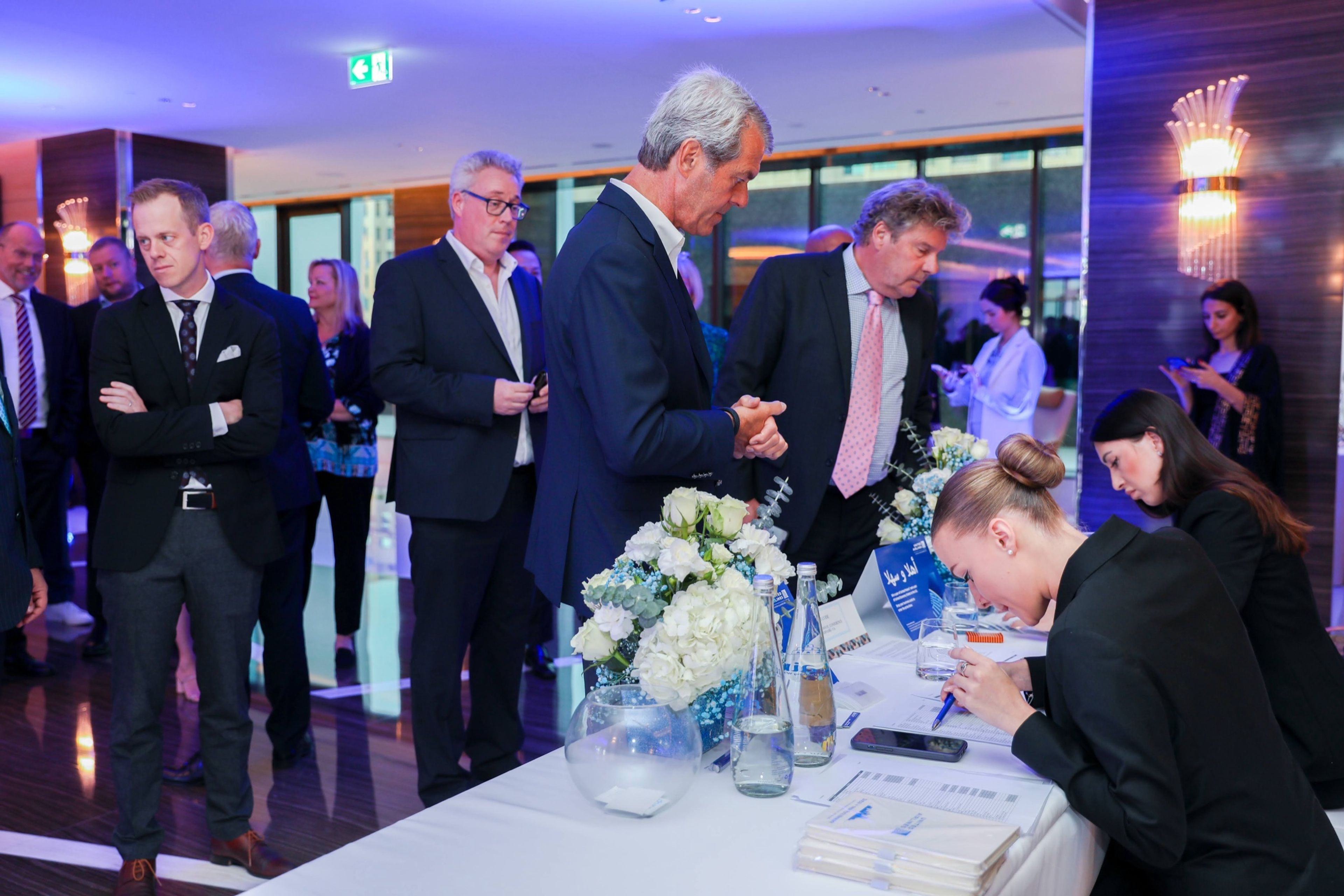 Executives signing an agreement at a corporate ceremony