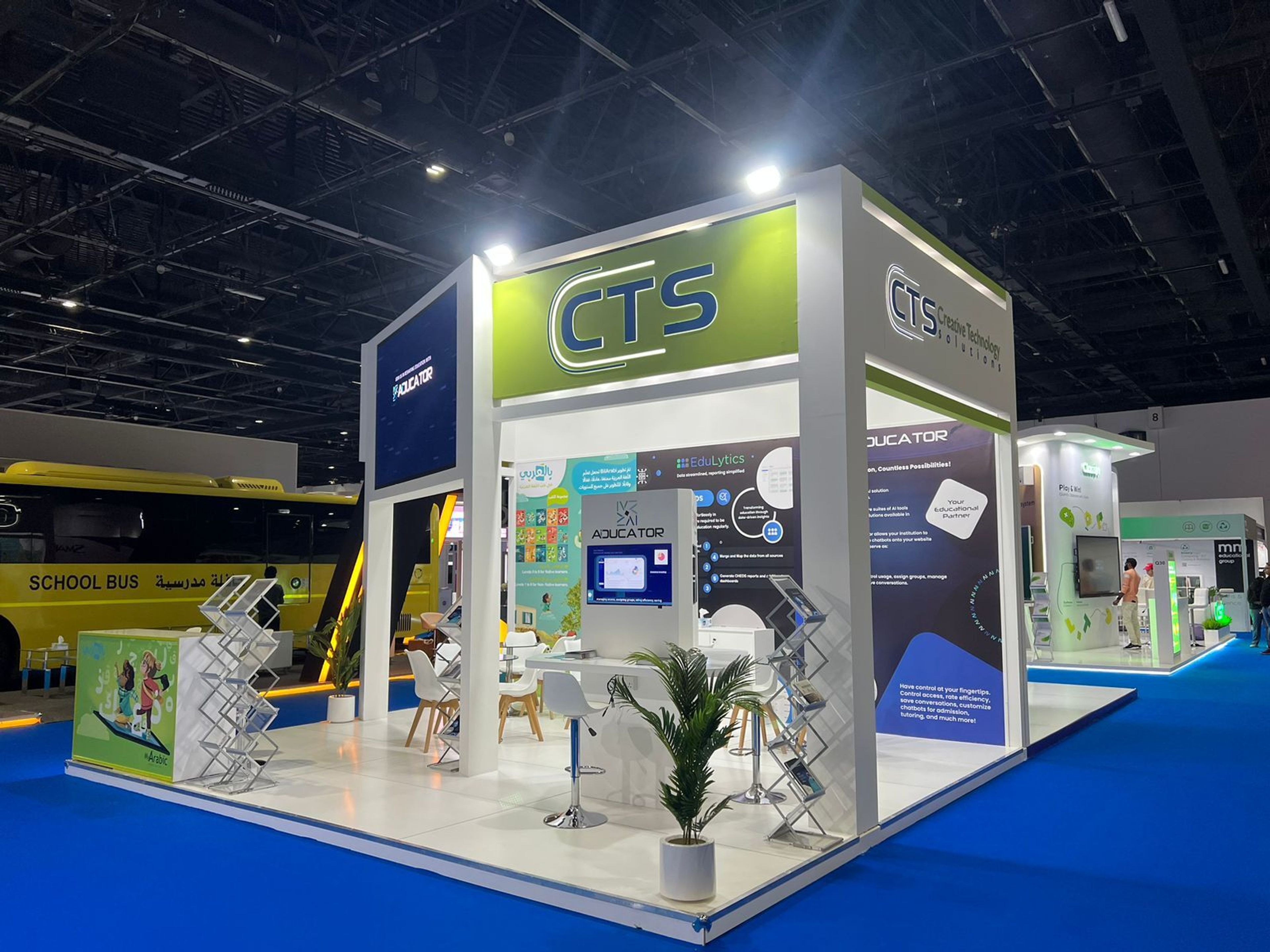Custom exhibition stand with blue and green branding at a Dubai trade show