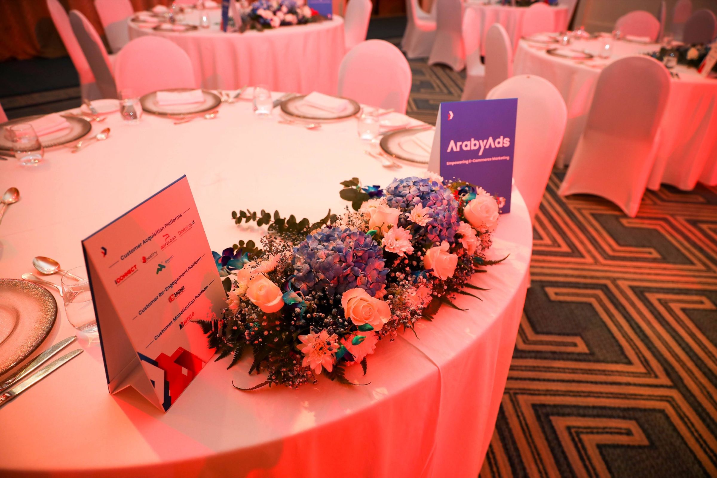 Table centrepiece with a name card and flowers at a gala dinner