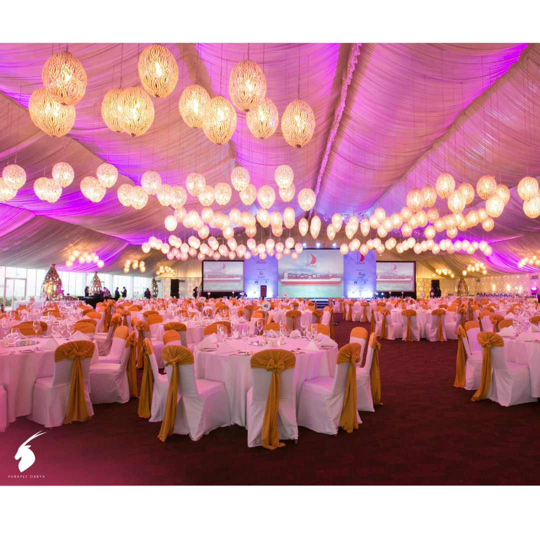 Ballroom gala dinner with a canopy of lanterns and gold chairs