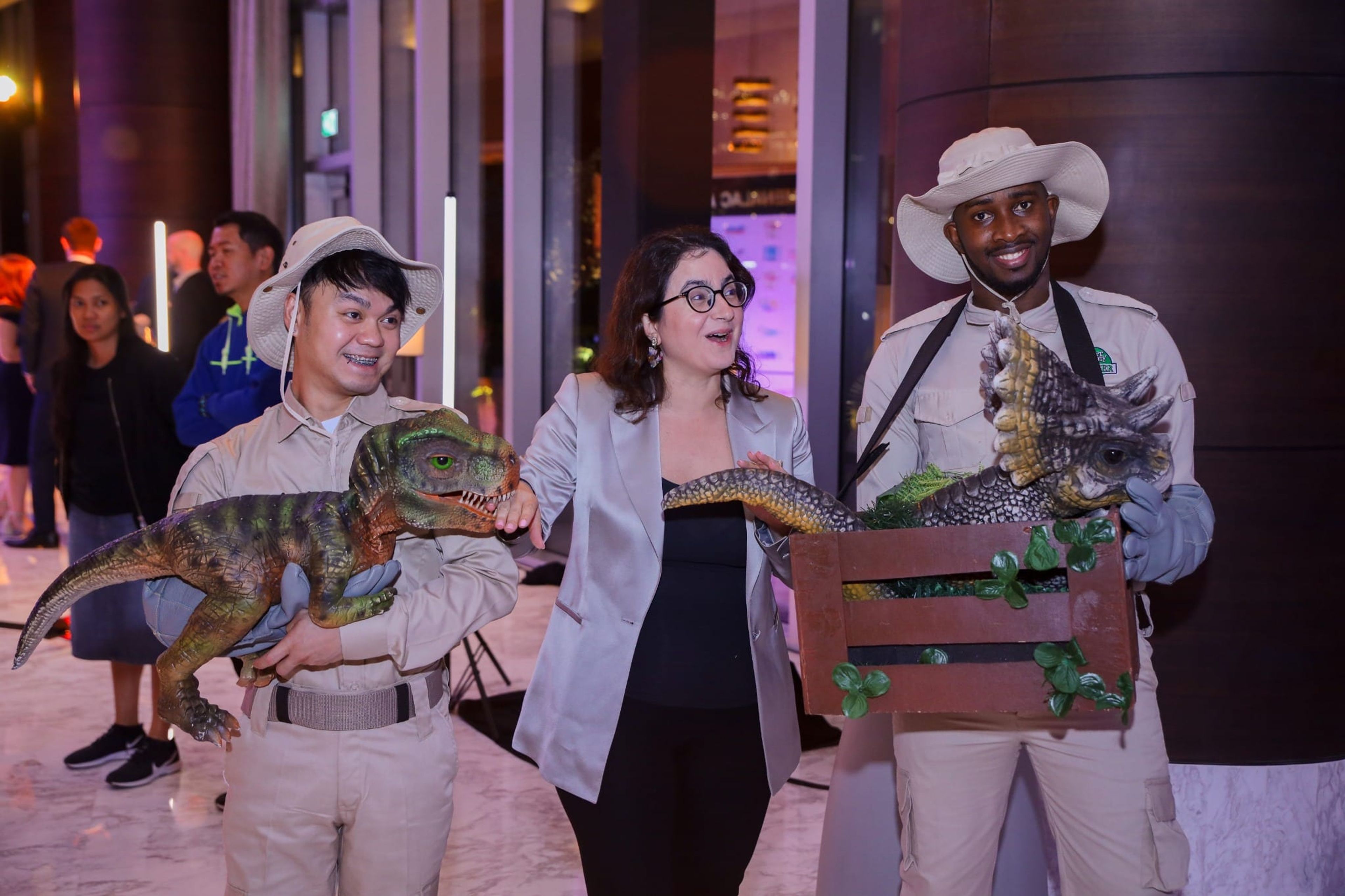 Dinosaur puppet entertainers greeting a guest at the MENALAC Awards