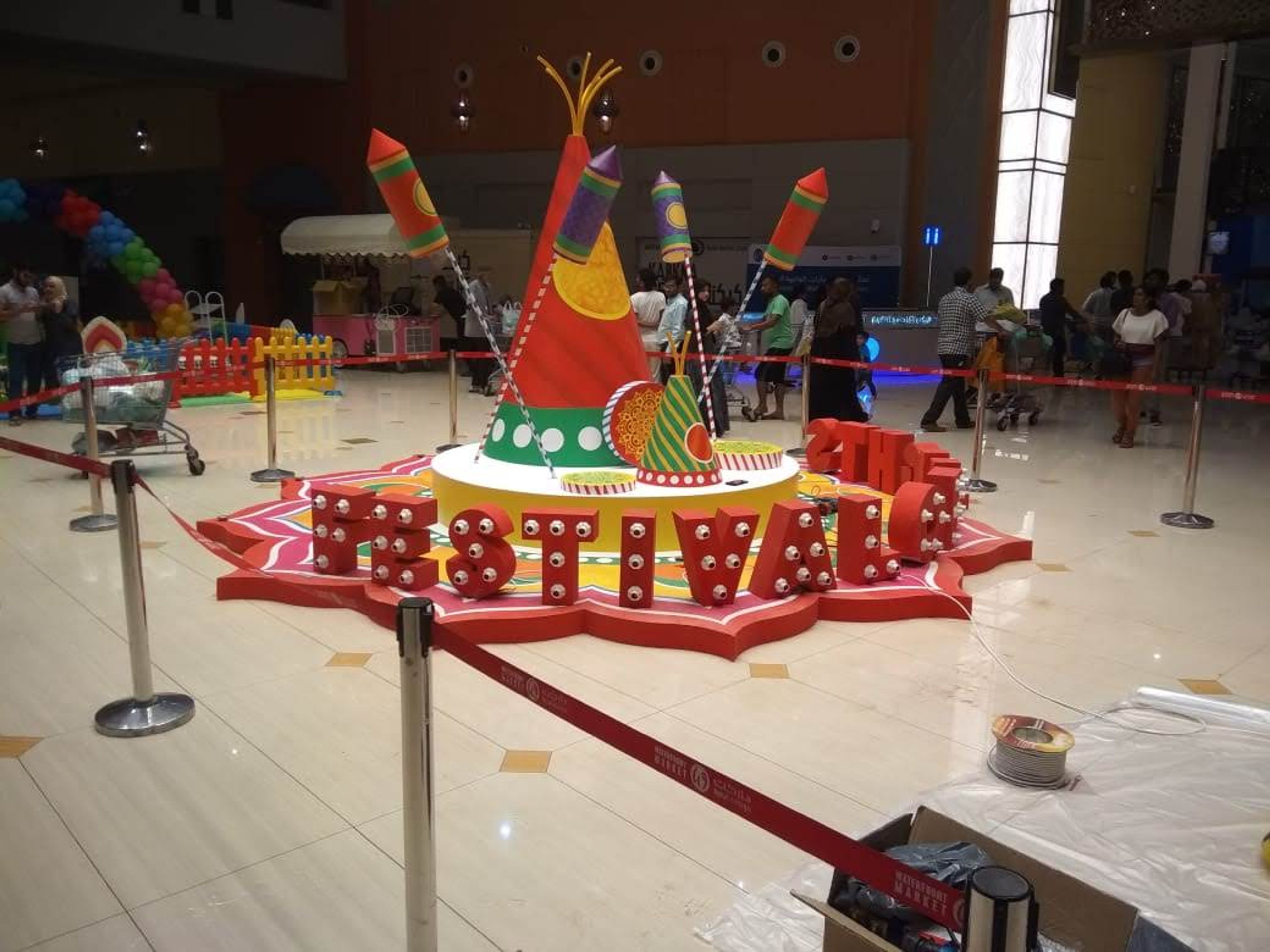 Custom-built festive installation in a mall atrium, cordoned off during setup