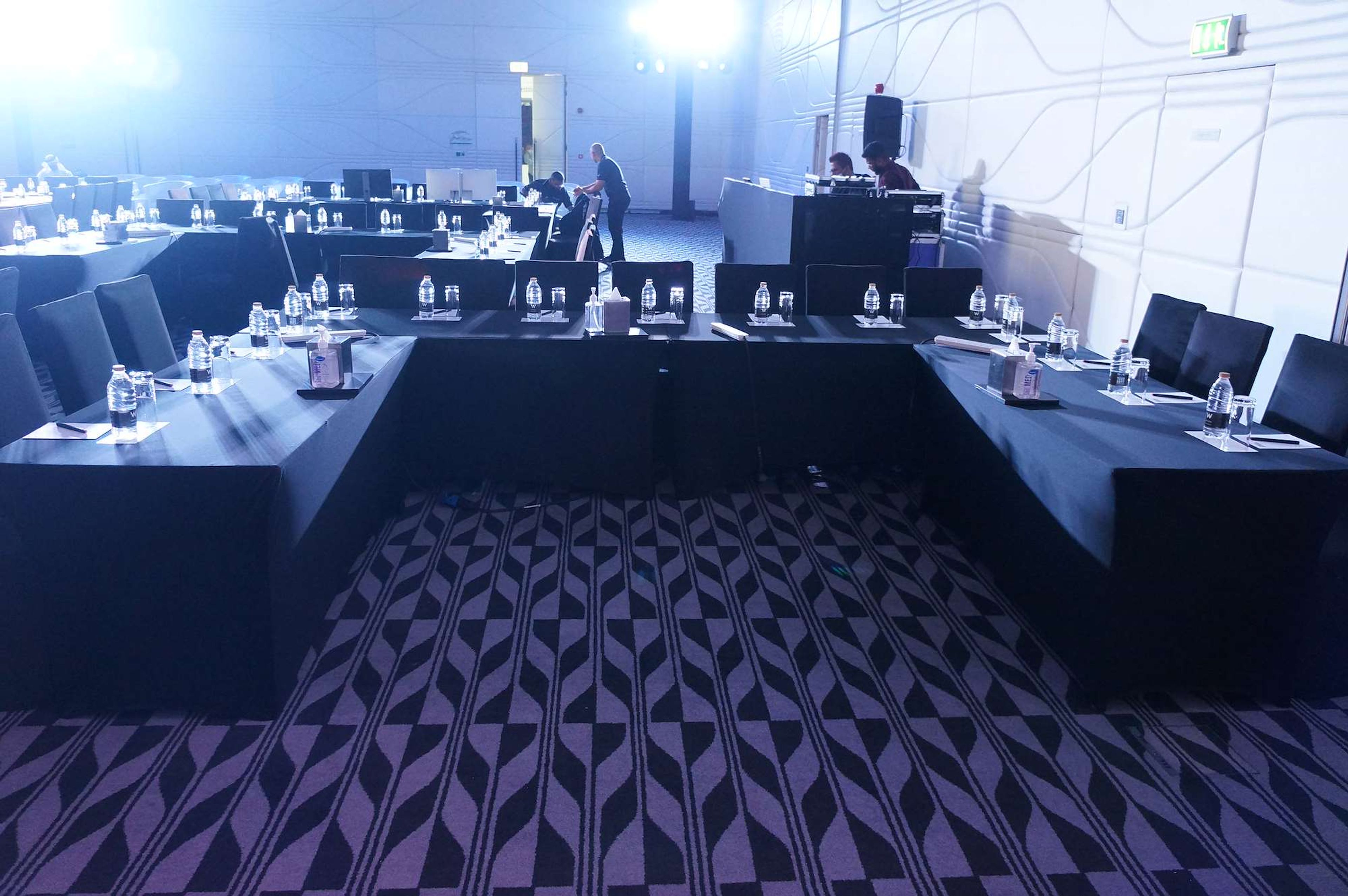 Conference room set in a U-shape with a technical control desk at the back, at a corporate event in Abu Dhabi
