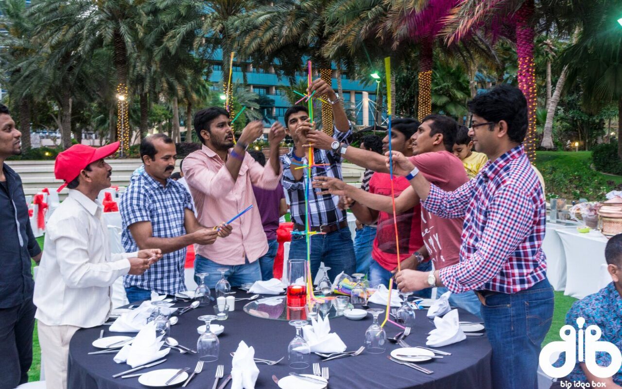 Guests raising their glasses at a lively corporate dinner