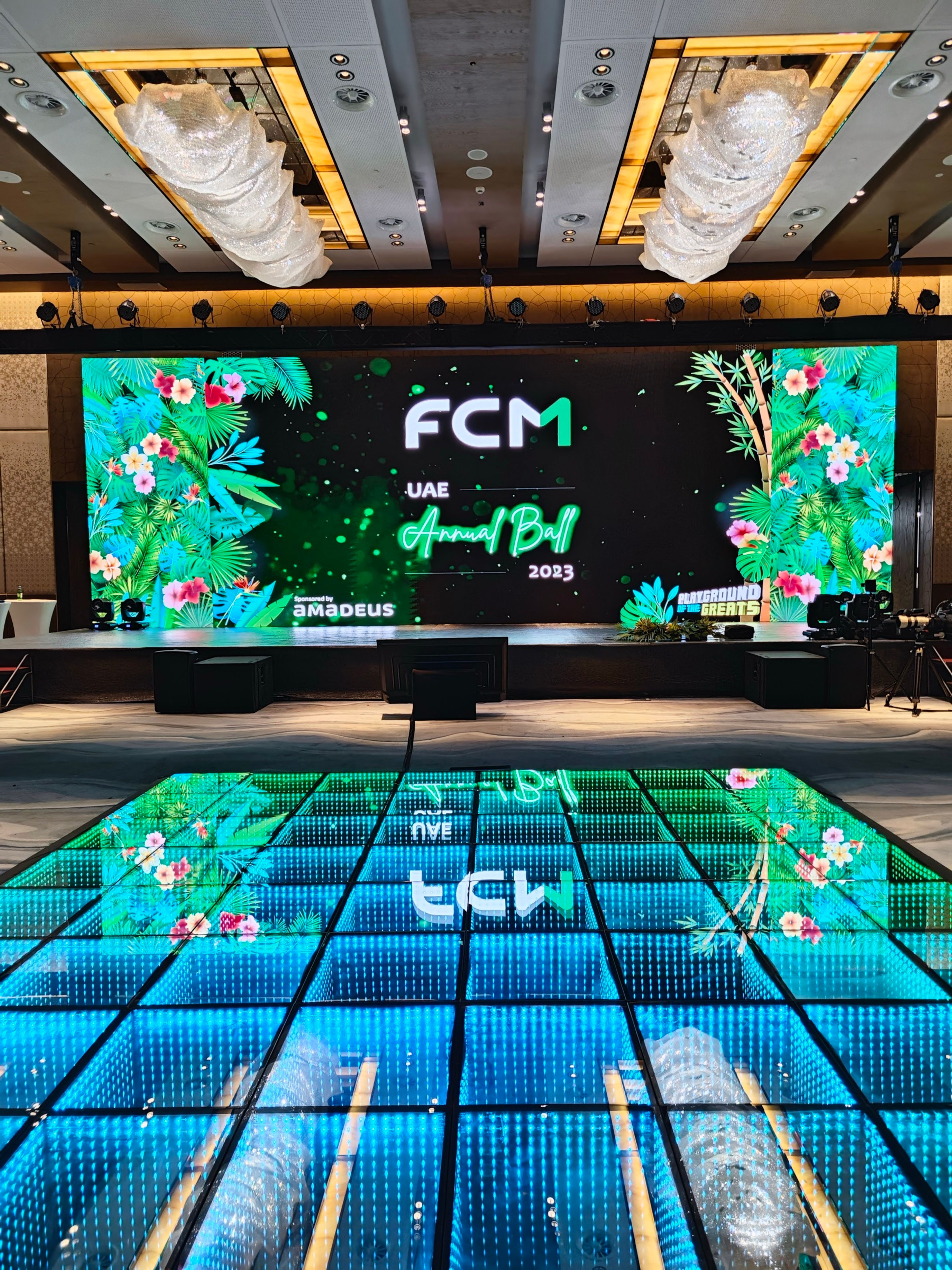 Stage with jungle-themed LED screens and an illuminated LED floor