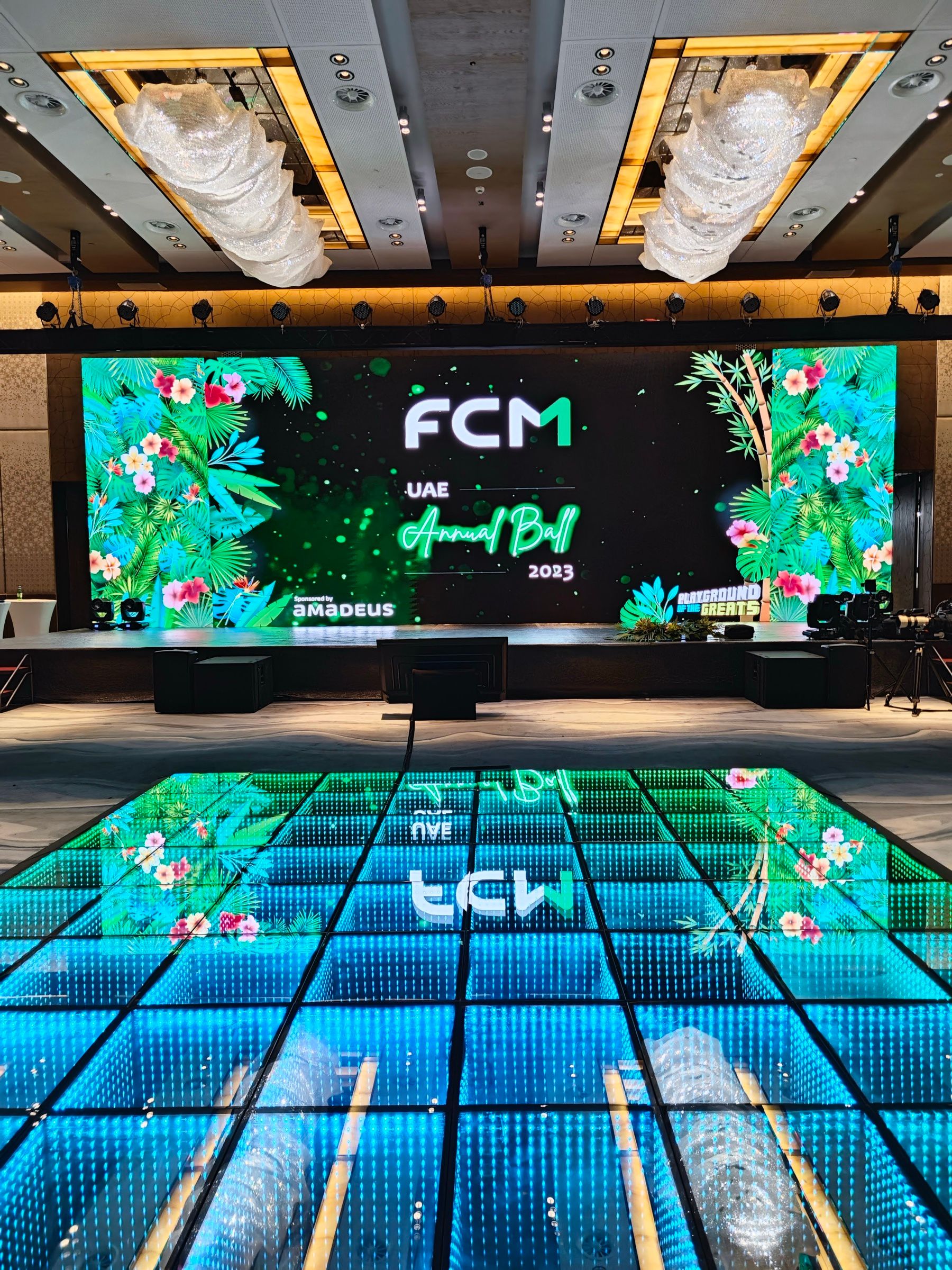 Stage with jungle-themed LED screens and an illuminated LED floor