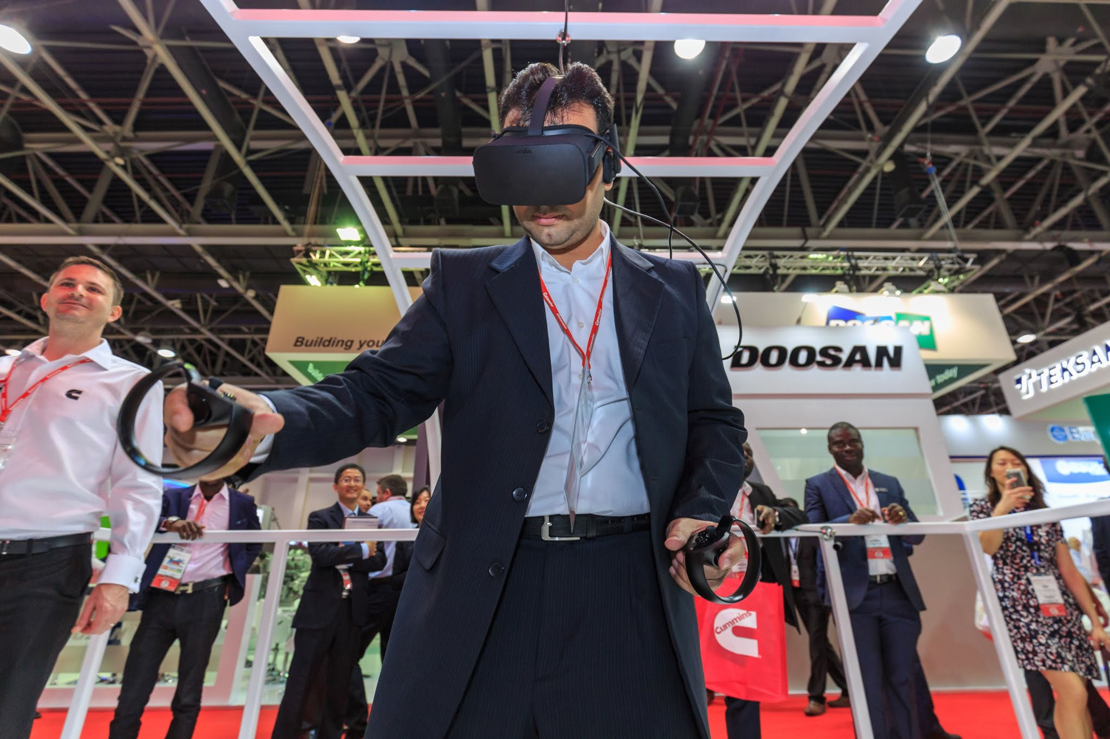 Close-up of a visitor interacting with a VR headset at an exhibition, demonstrating the use of cutting-edge technology to enhance the attendee experience