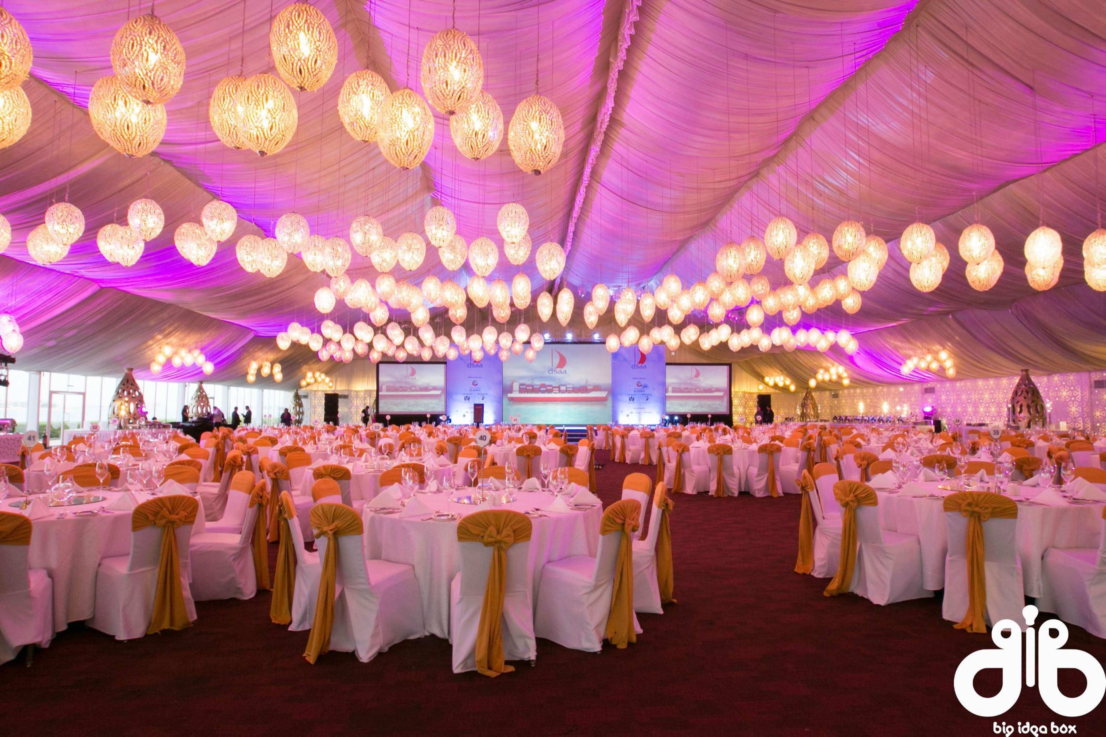 Ballroom gala dinner with a canopy of lanterns and white chiavari chairs