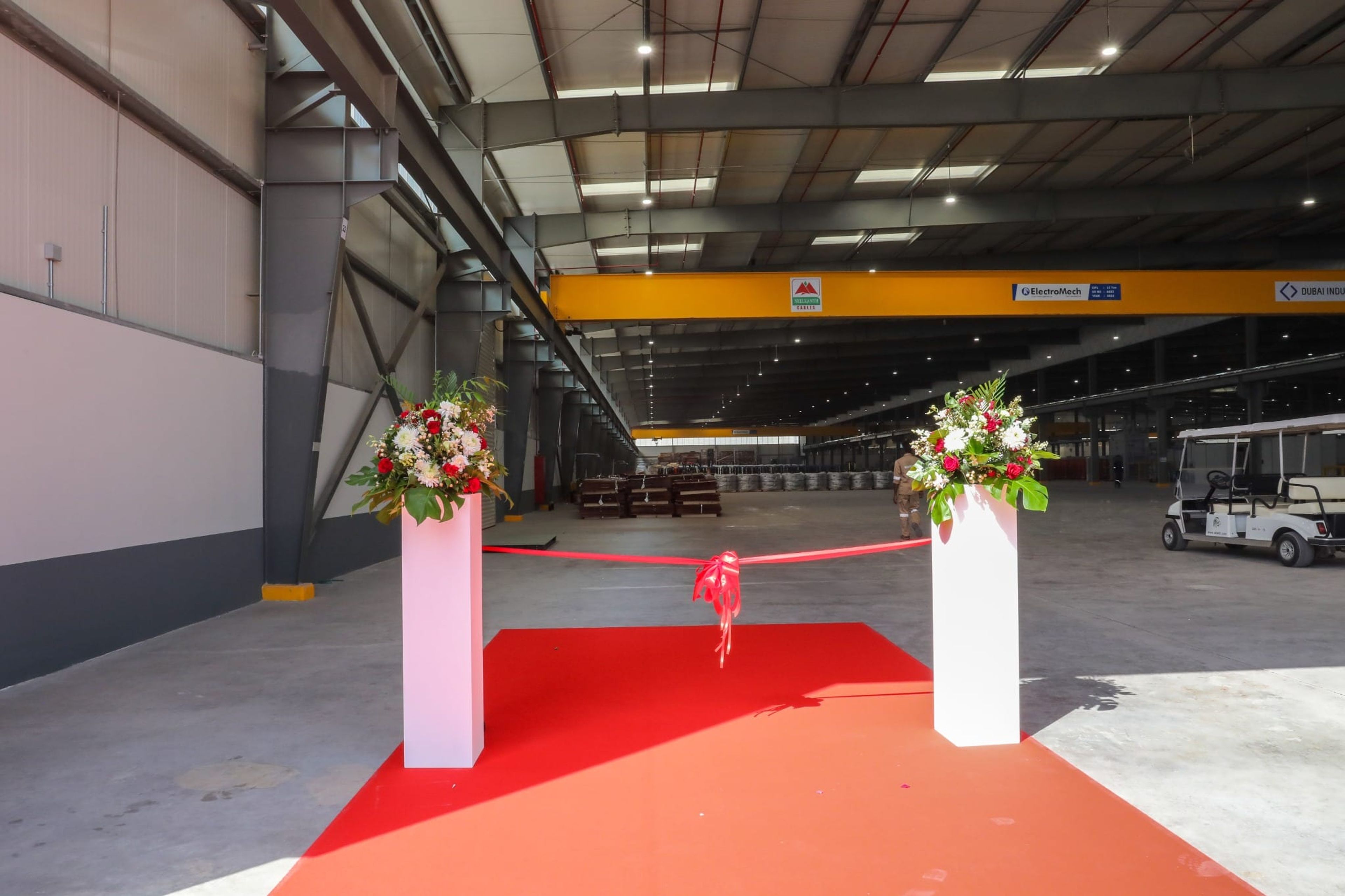 Ribbon and red carpet set at the factory doors for the opening ceremony