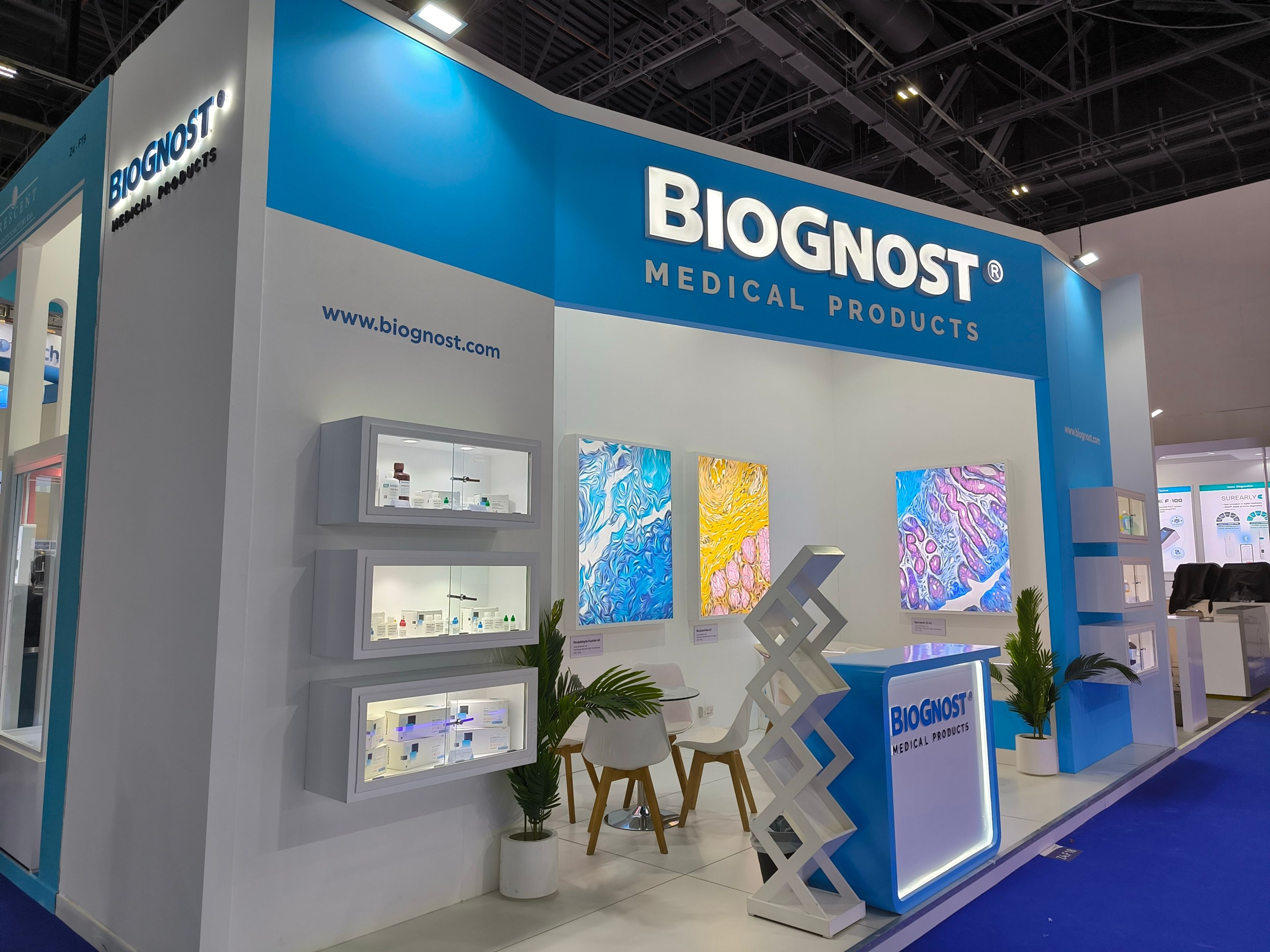 A large exhibition stand with vibrant lighting, signage, and digital elements, providing an immersive experience for event attendees.