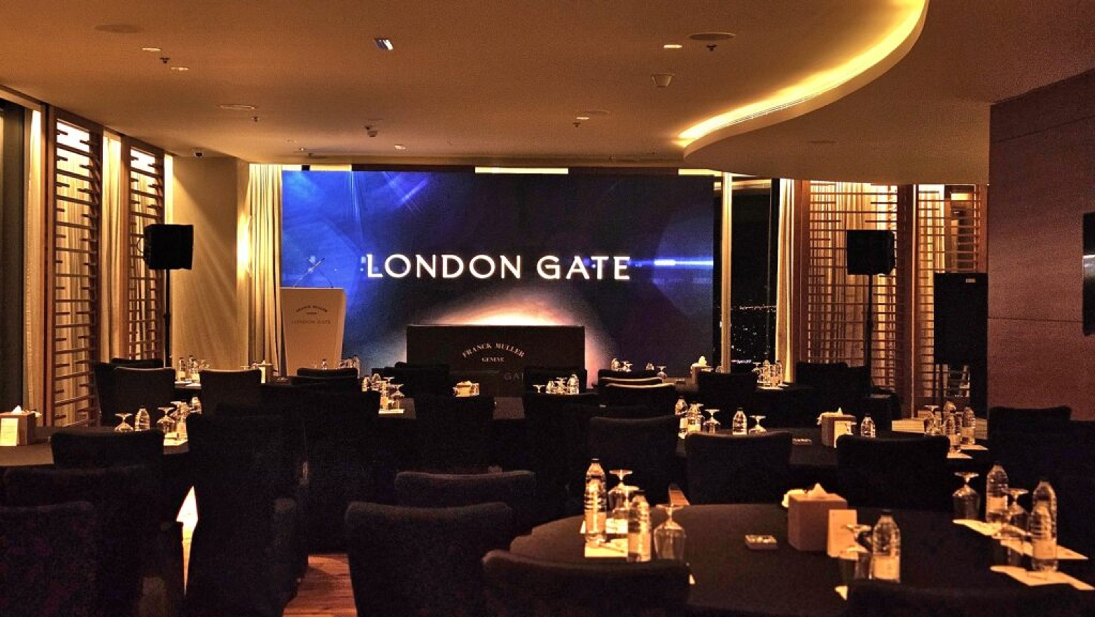 Stage with a large screen and moody lighting at a corporate evening event