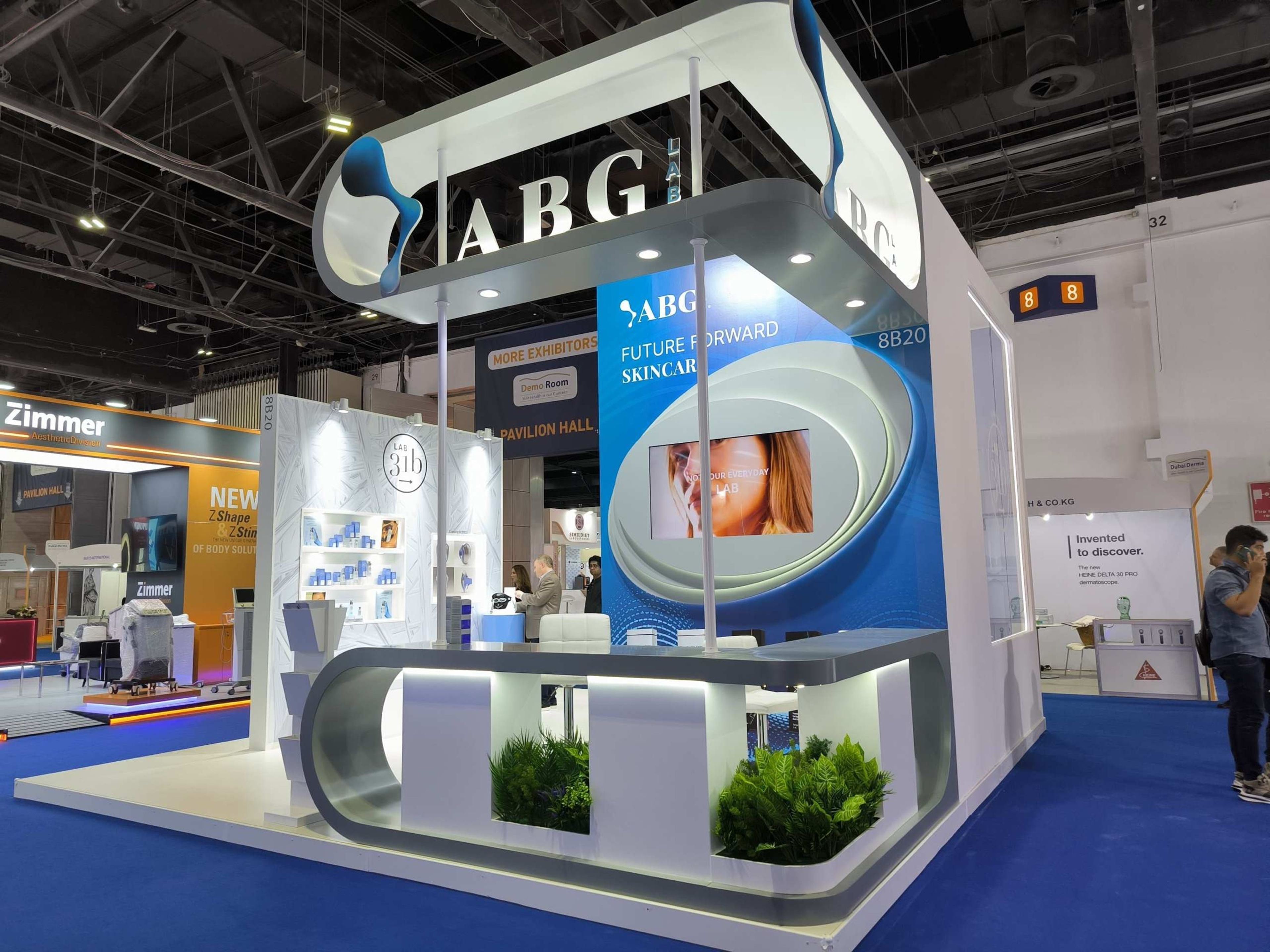 Exhibition booth with a curved branded wall and product display counters