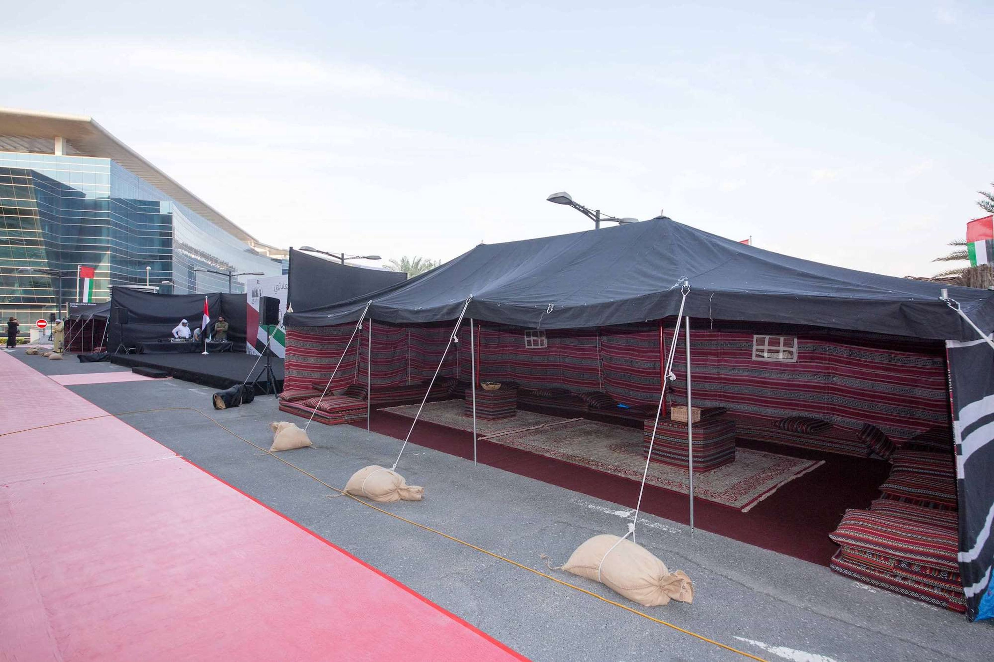 Black Bedouin tent with majlis seating set up for a corporate UAE National Day heritage village