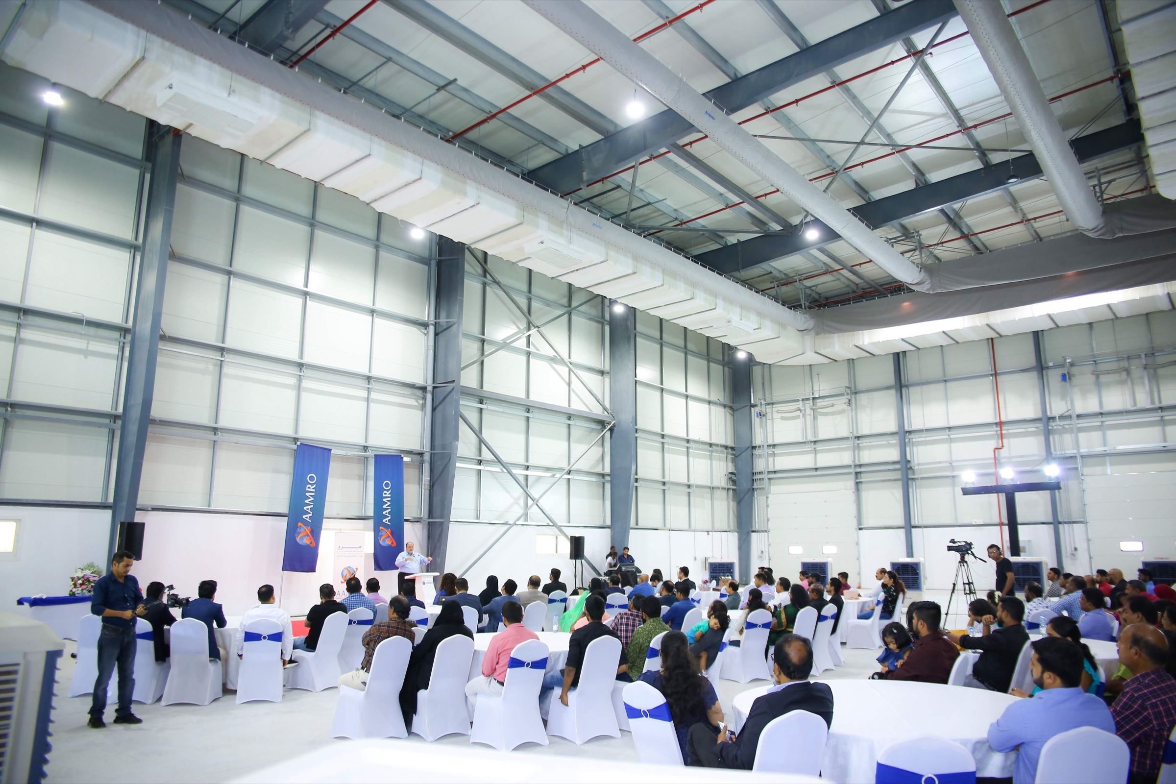 Warehouse event space with rows of seating for a corporate gathering