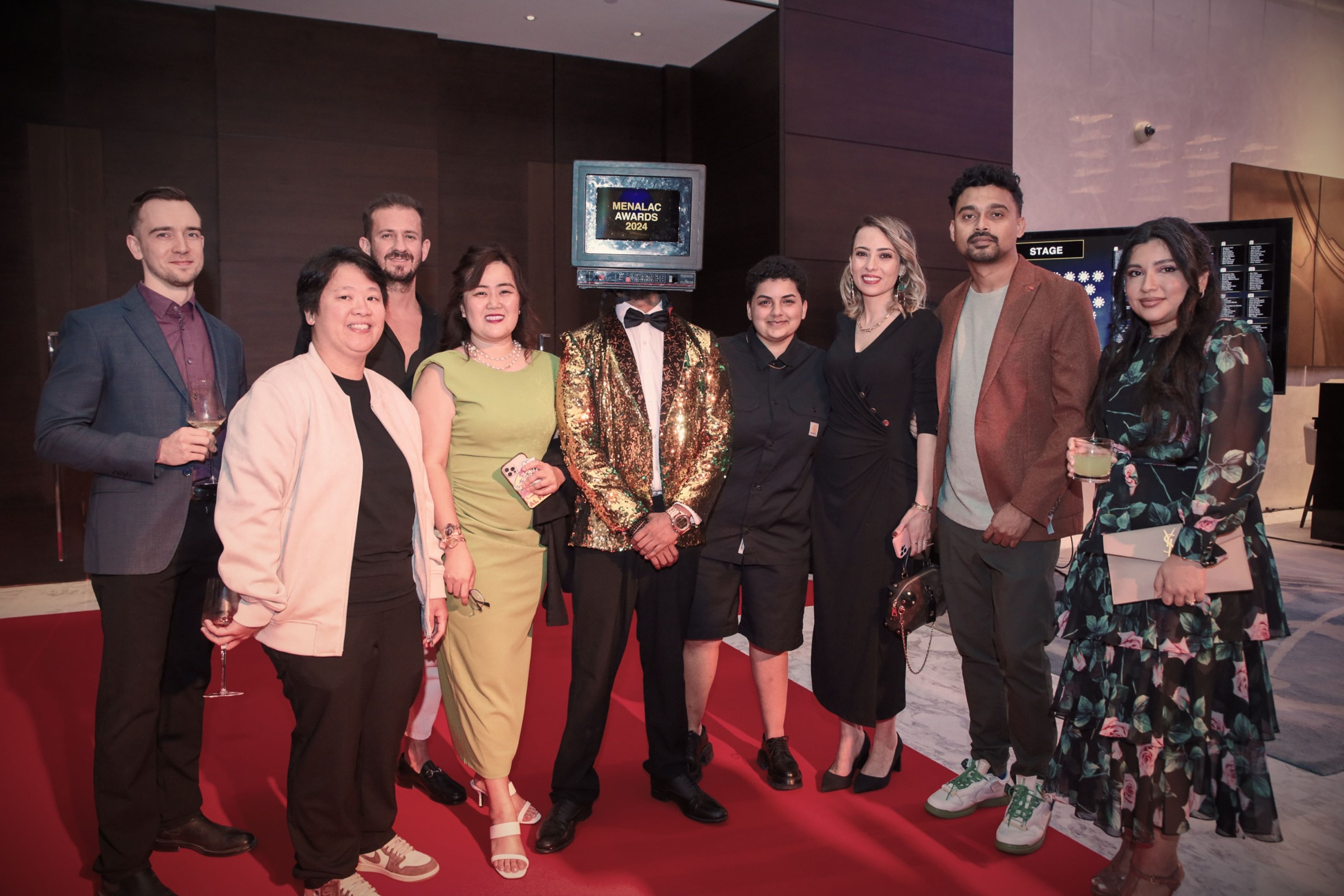 Guests posing together on the red carpet at a corporate event