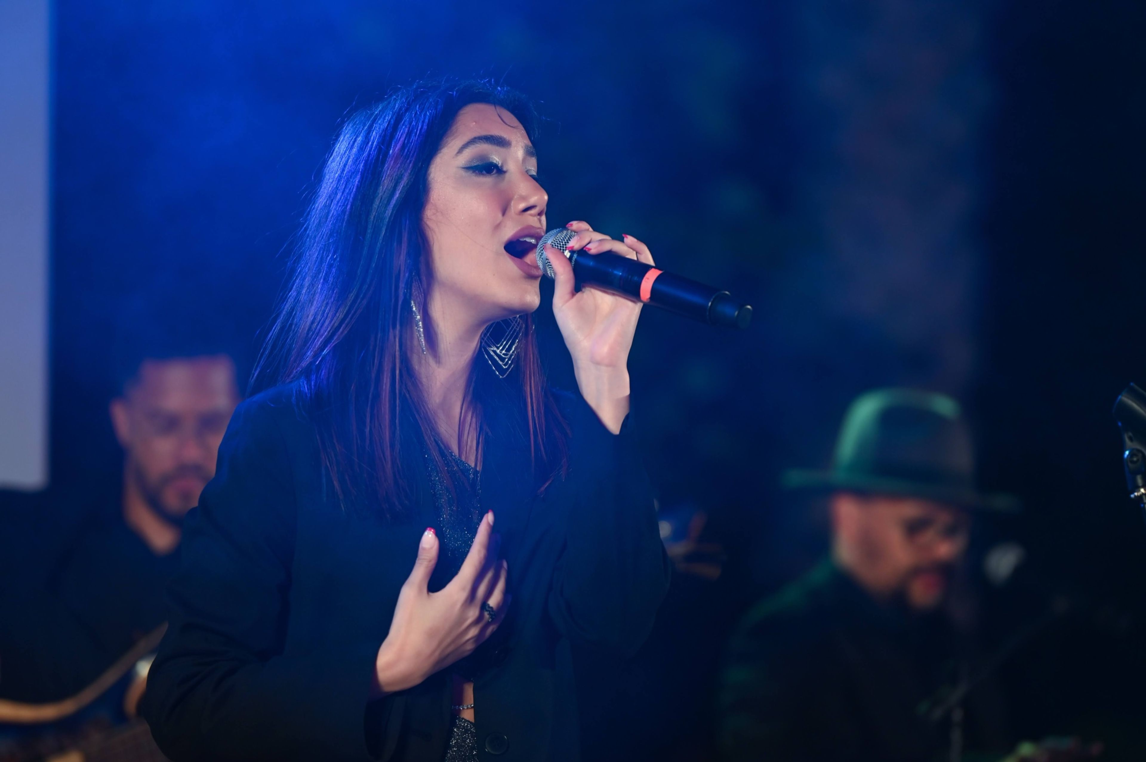 Singer performing live at an evening corporate event