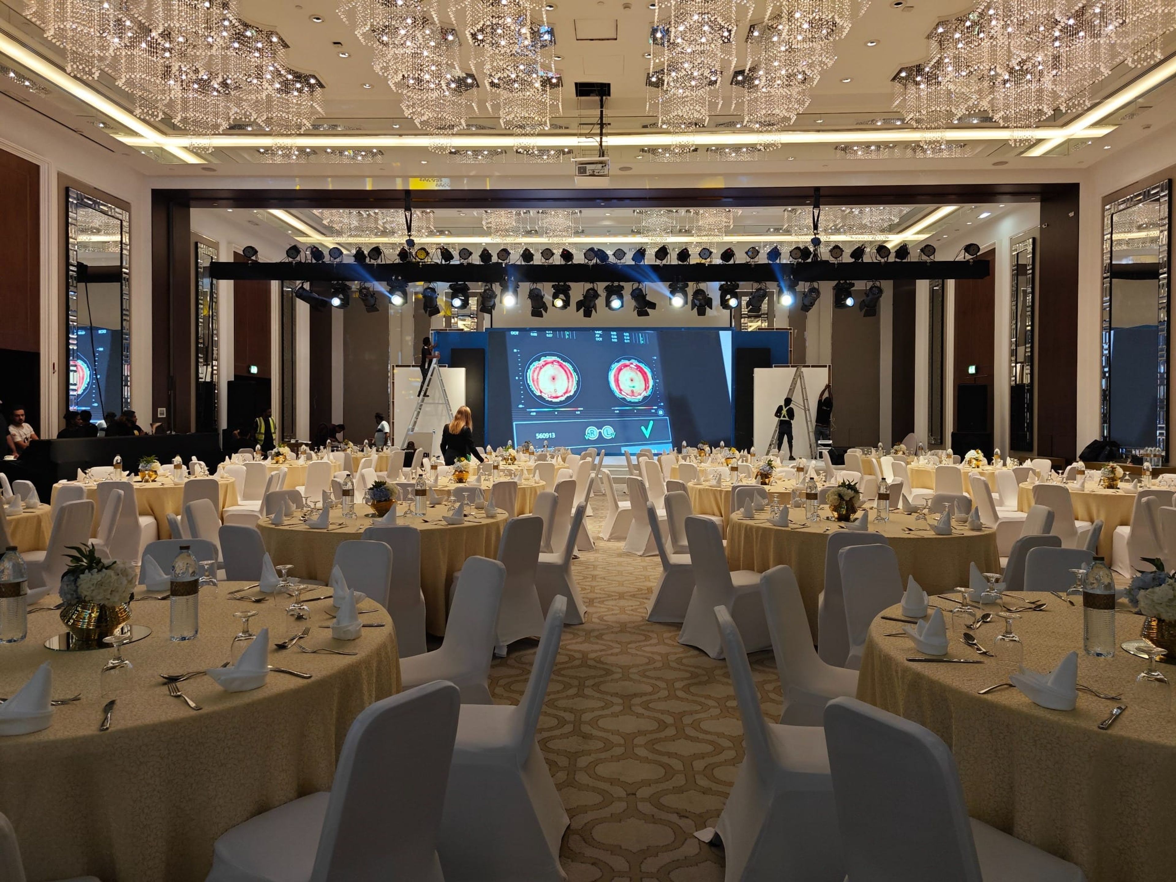 Ballroom set with round tables and stage truss before the Tokai gala