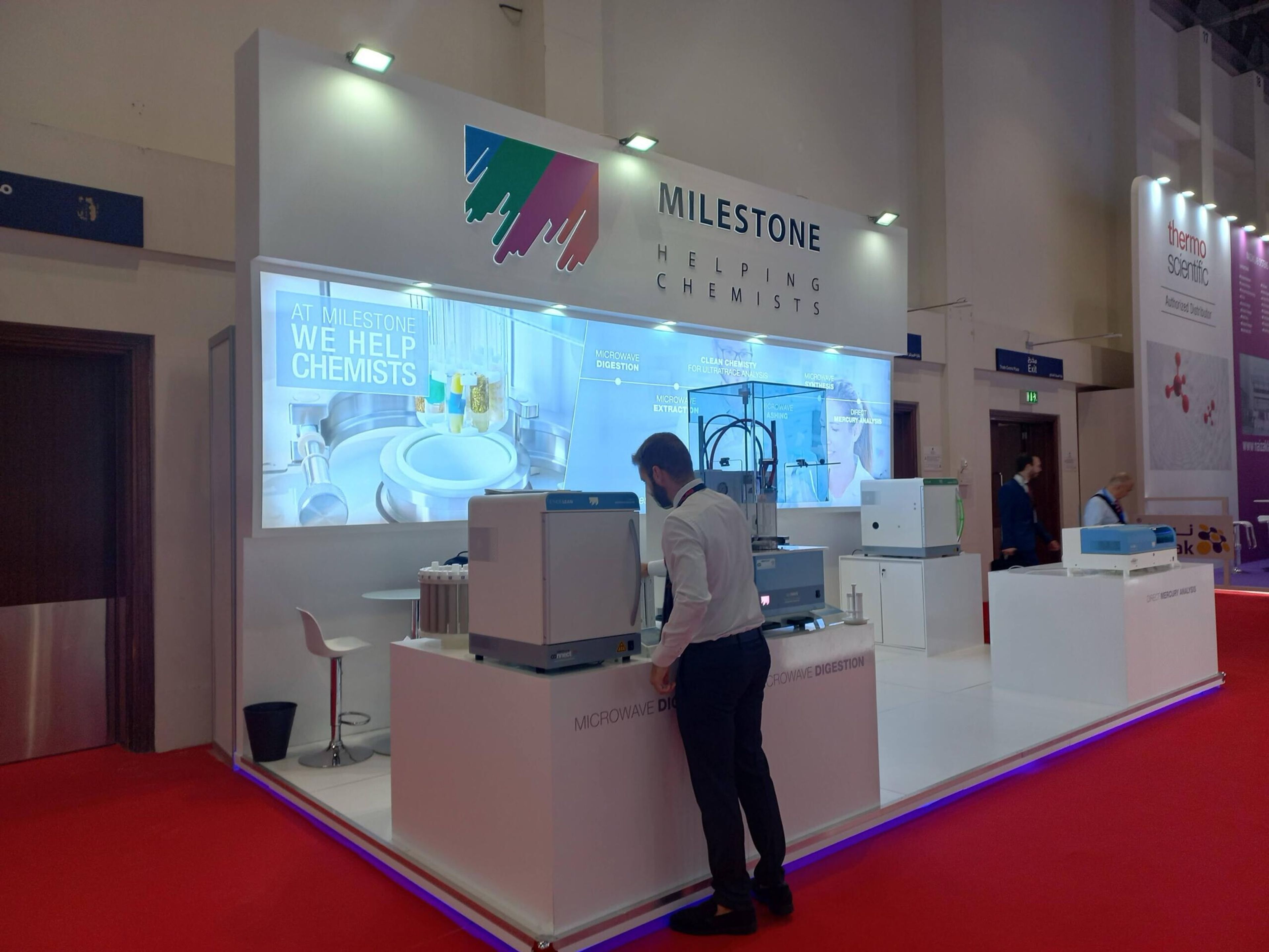 Exhibition stand with a large screen and product counter