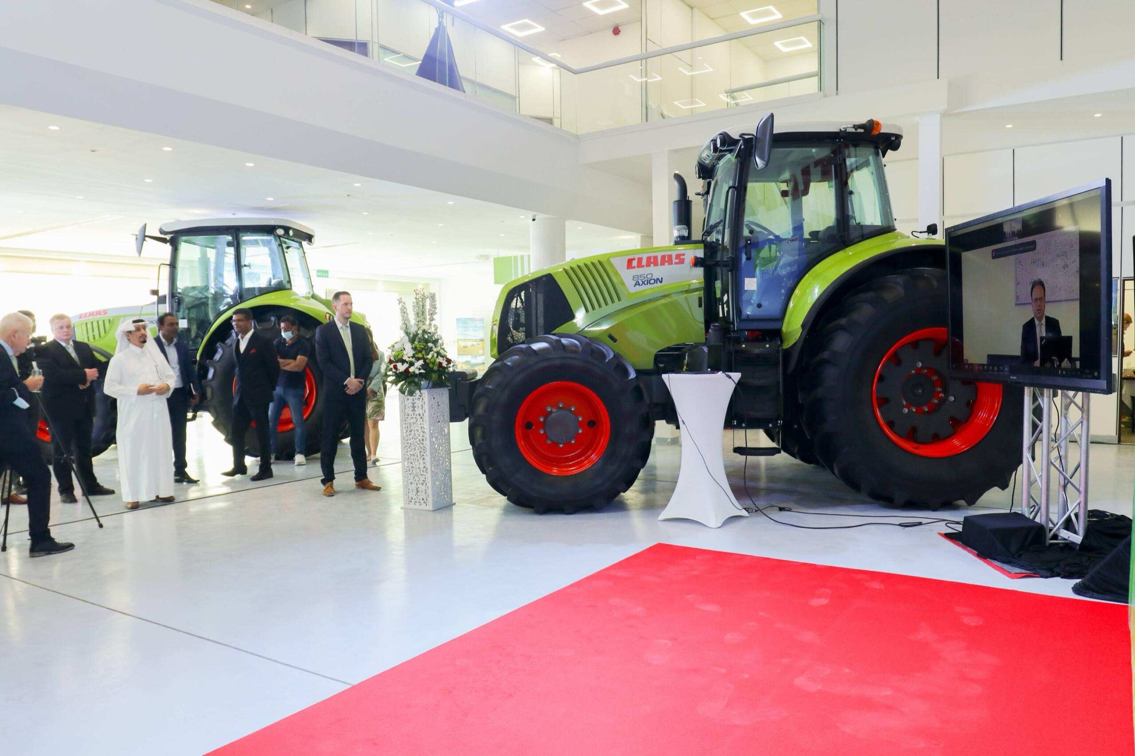 Guests viewing a tractor displayed at a corporate product launch