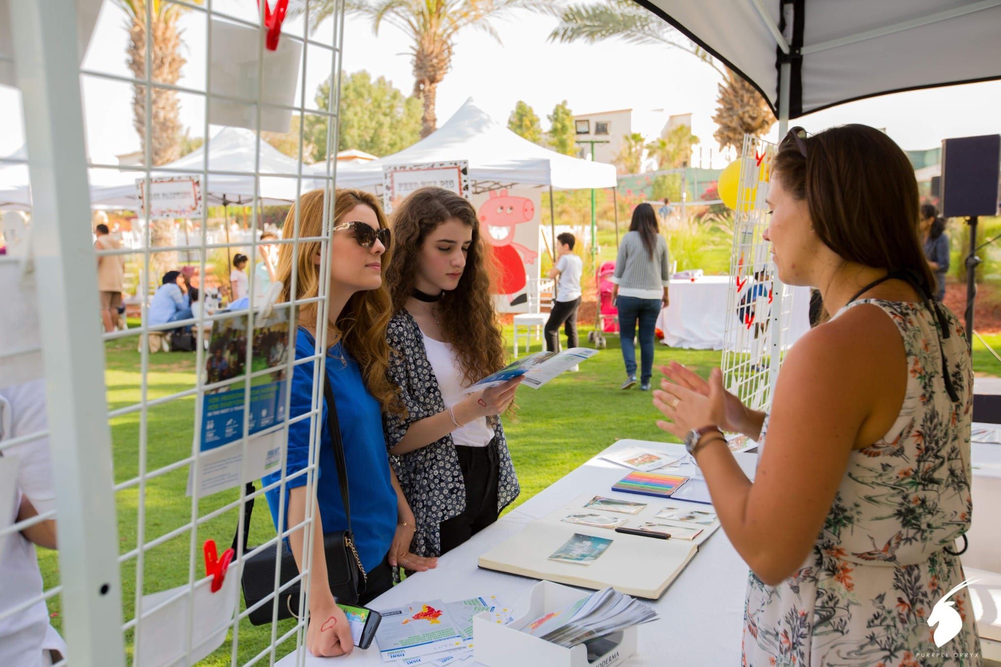 Bioderma team member talking to guests at a product information stand