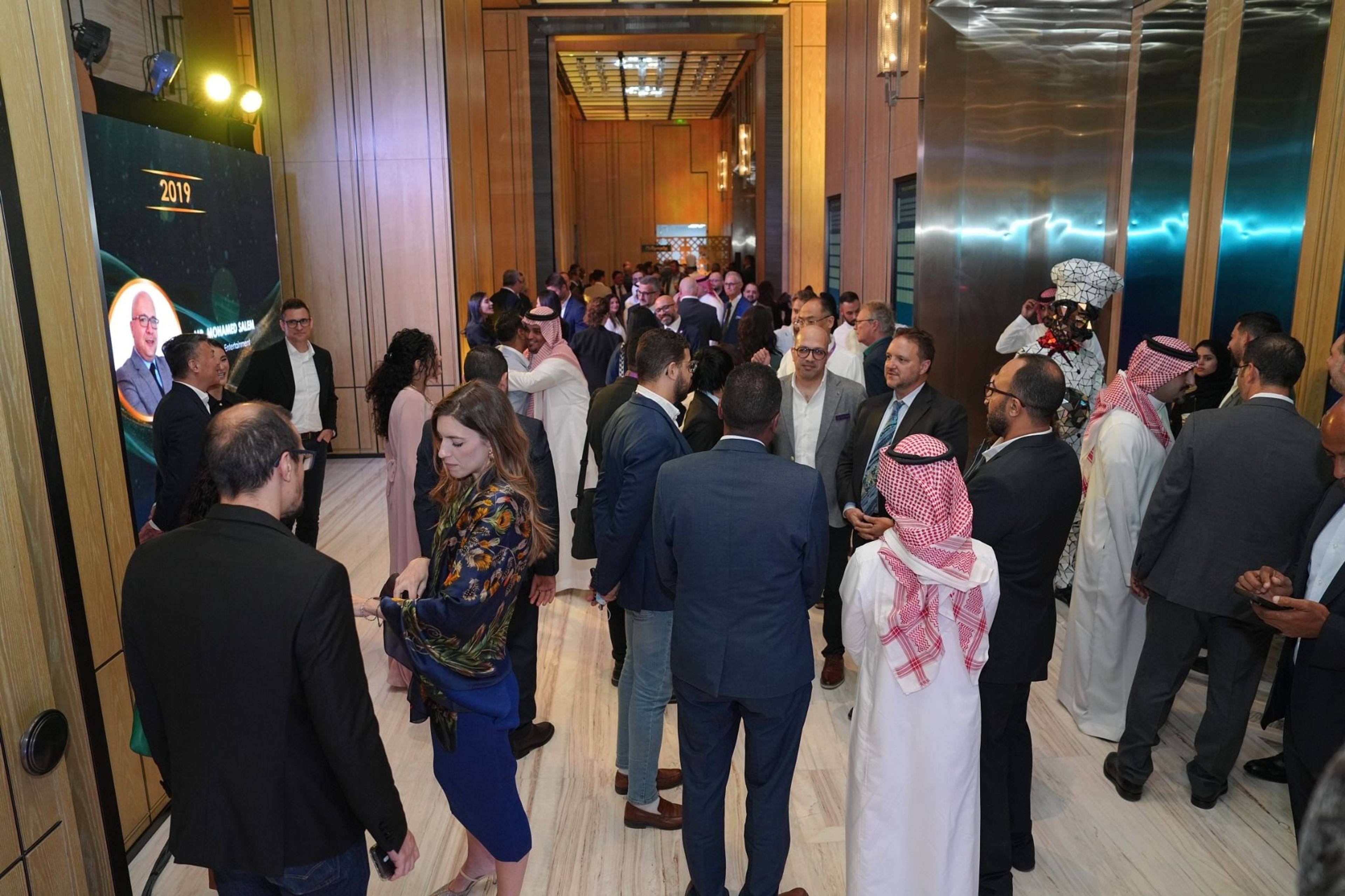 Guests mingling in small groups at the MENALAC awards networking reception