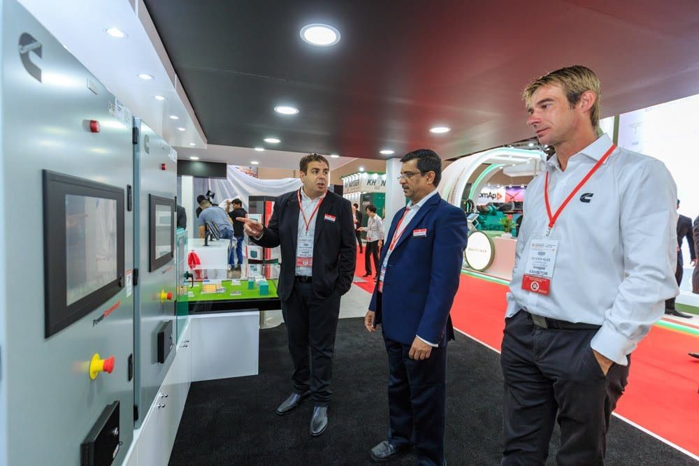 Visitors at an interactive control panel display on the Cummins stand